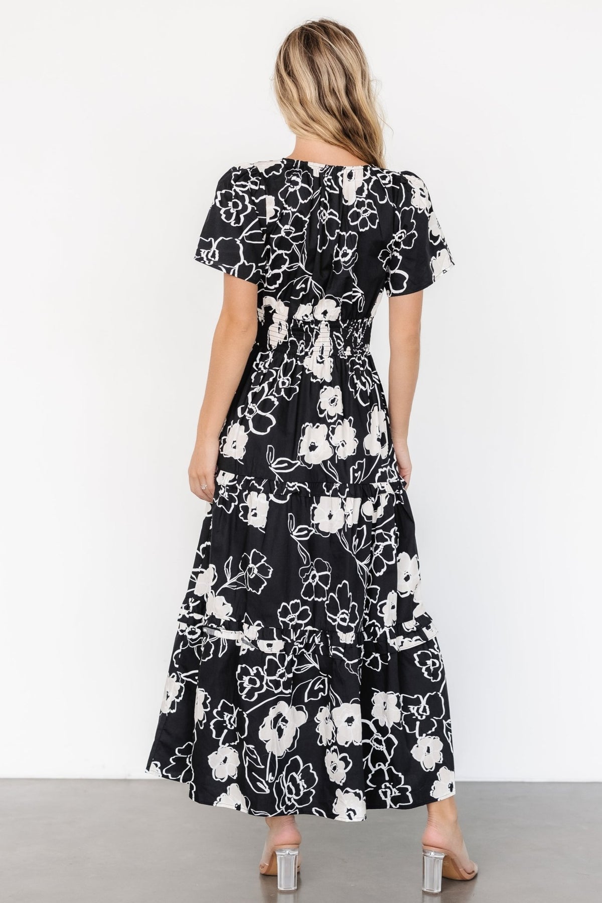 Close detail of the smocked waistband on the Kiana Poplin Maxi Dress in black and cream, showing stitching and fit shaping.