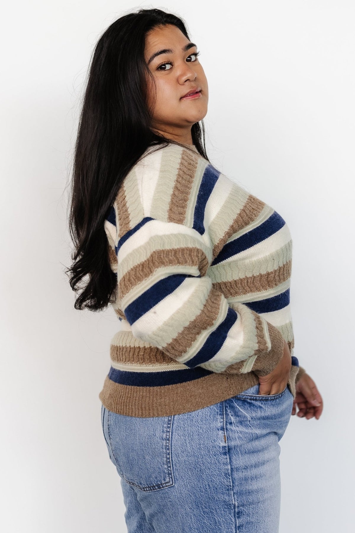 Studio shot of Kira Striped Sweater highlighting stripe contrast in navy, sage, natural and ivory with ribbed trim close-up.
