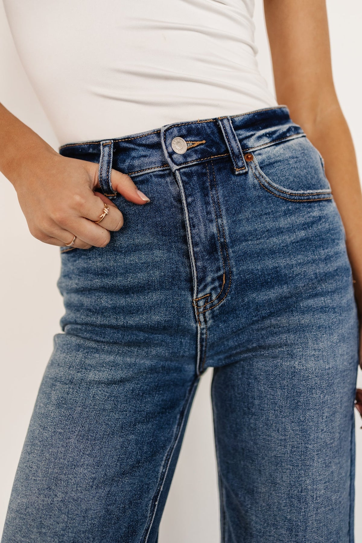 Styled outfit image: Kirby medium wash wide-leg jeans paired with a fitted sweater, showcasing natural drape and cropped hem.