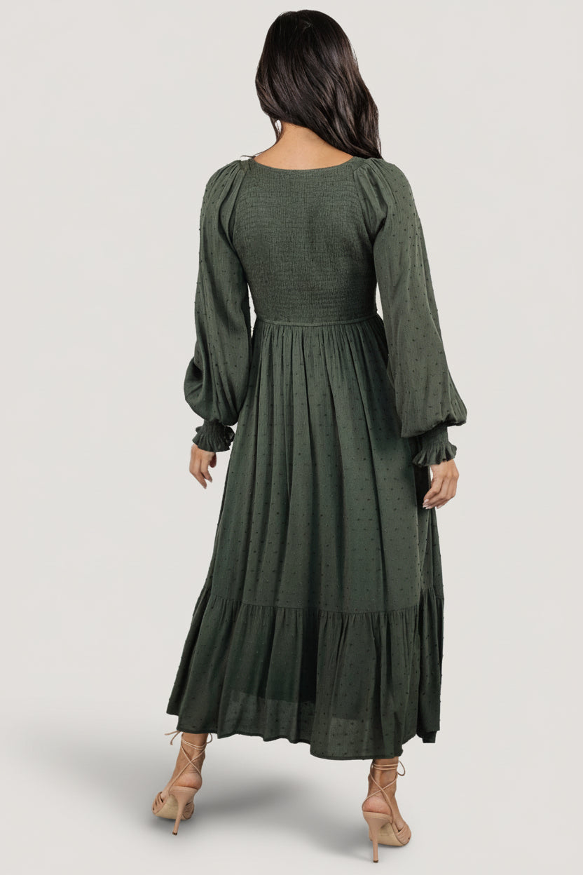 Full-length shot of model in deep olive Lainey dress highlighting the relaxed fit and lined skirt movement.
