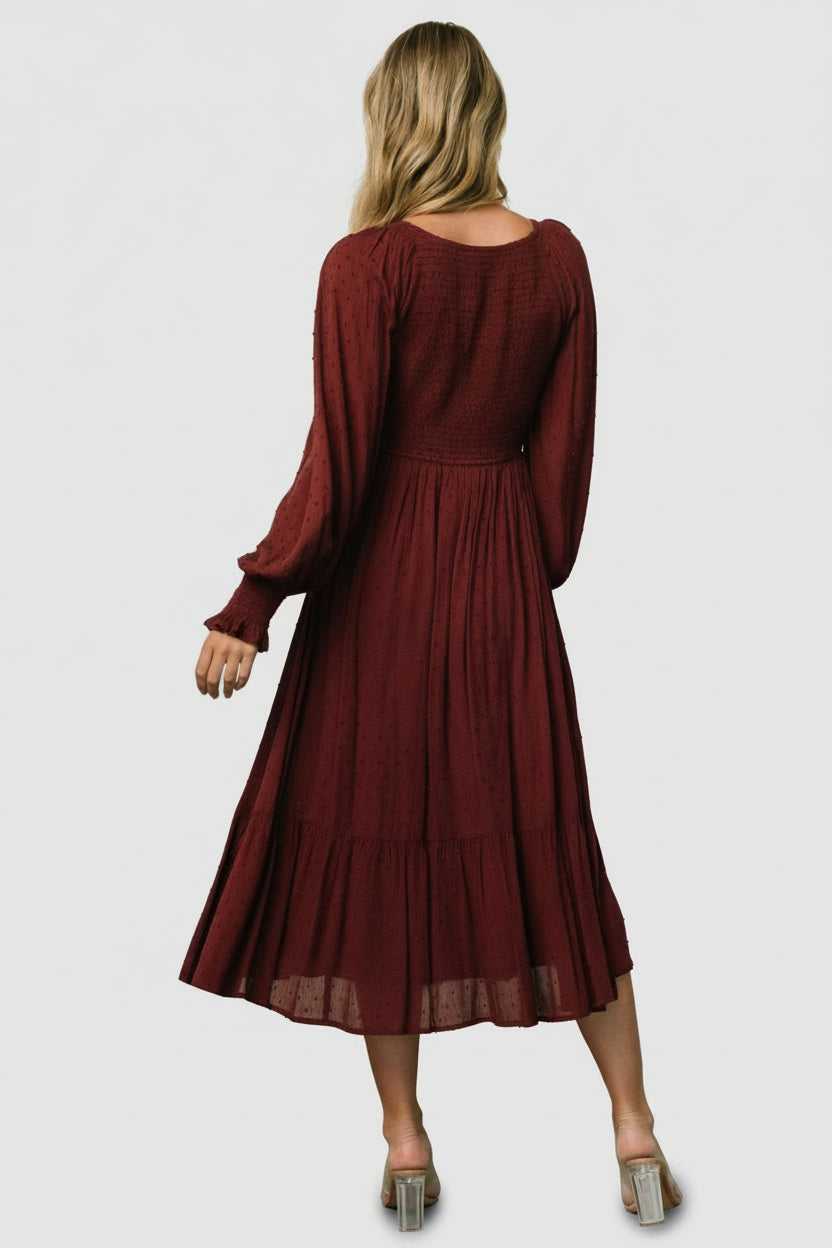 Side view of Lainey mulberry midi dress showing V-waist silhouette, tiered hemline, and the dress’s graceful drape while walking.