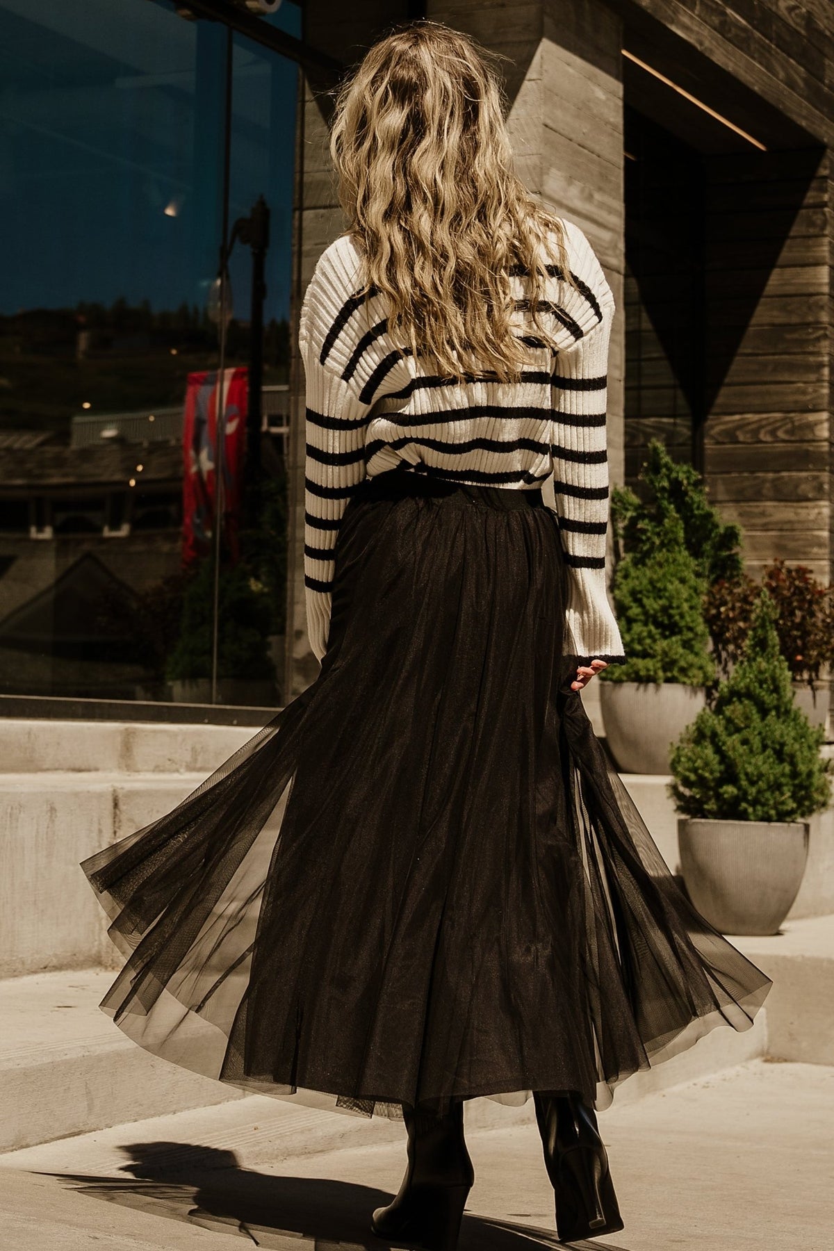 Close-up of ribbed knit texture and stripe pattern on Landell sweater, highlighting fabric stretch and stitch detail.