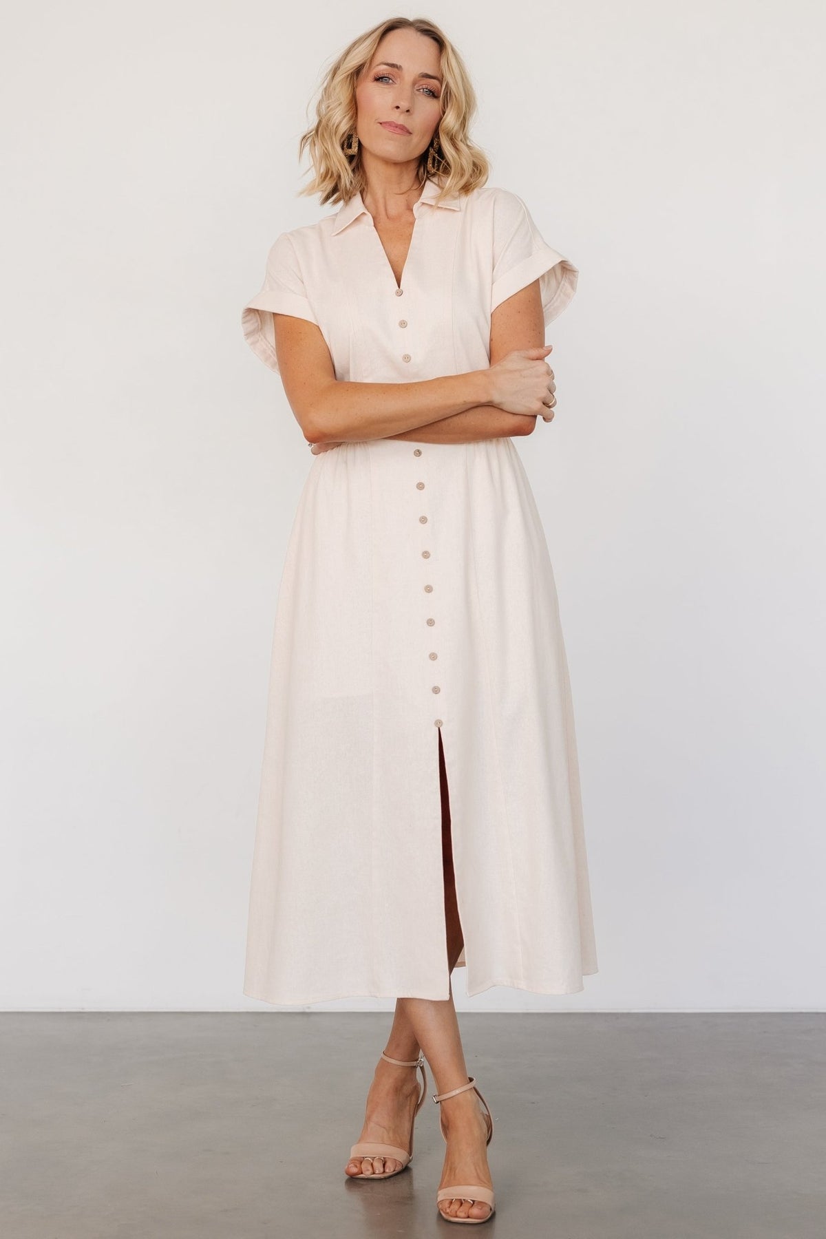 Detail of faux button placket, vertical seams and front slit where the buttons end, illustrating styling and closure details on the dress.