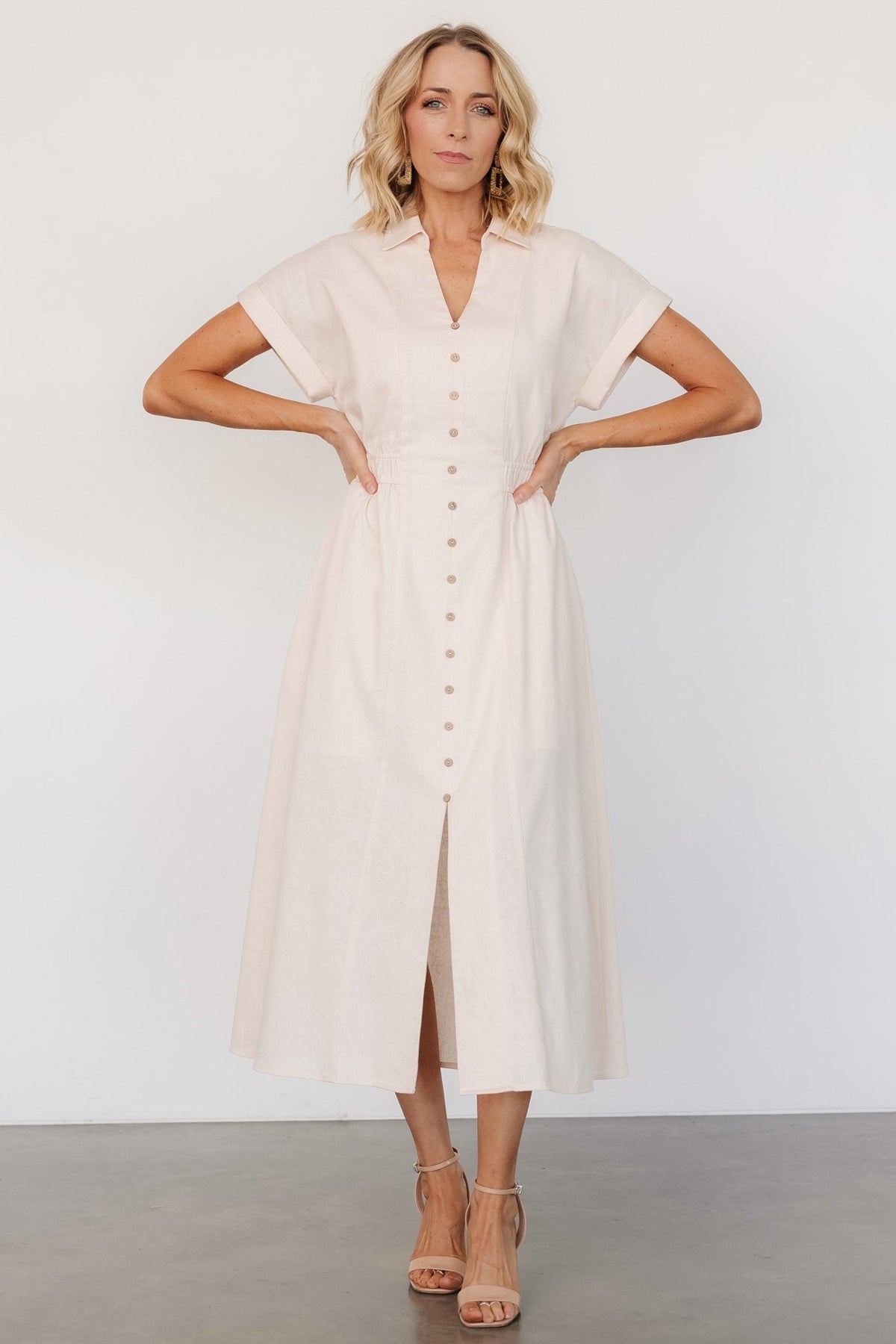 Fabric texture close-up showing the 70% cotton and 30% linen woven surface and natural color tone of the midi dress.