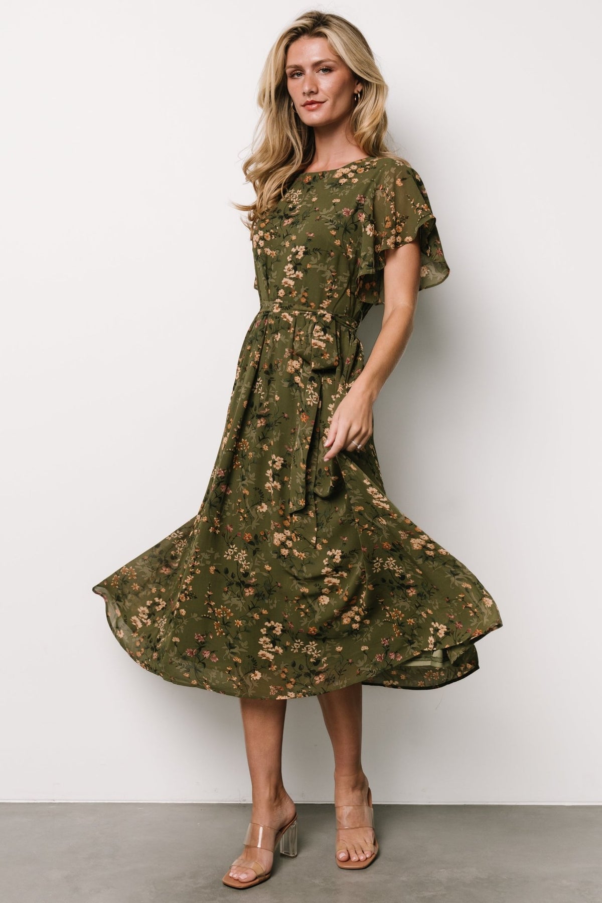 Fabric detail shot showing the chiffon texture, fully lined body and the soft floral pattern in muted tan, pink, green and cream tones.