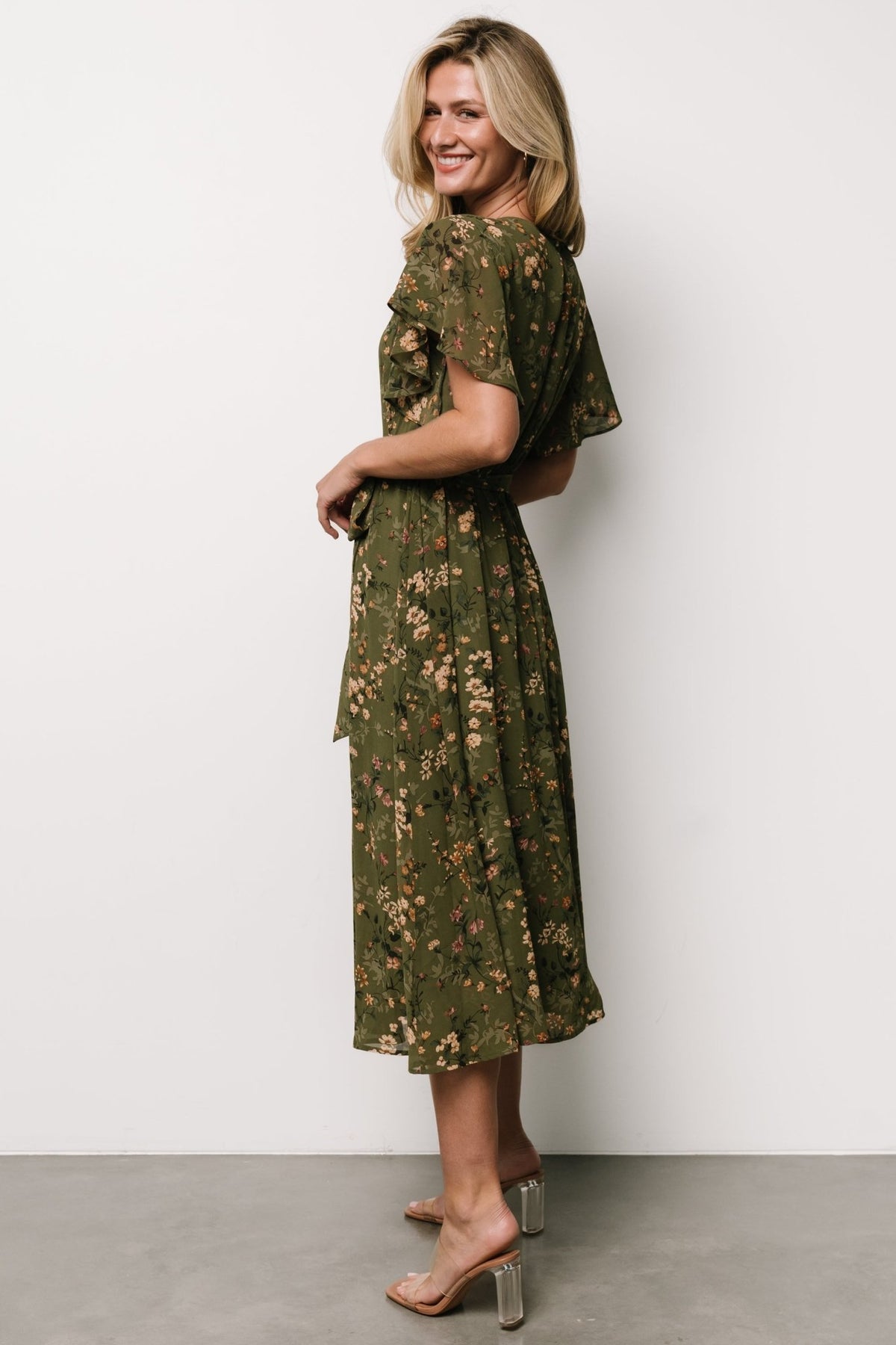 Close-up of sheer flutter sleeve and delicate muted tan, pink, green and cream floral print on non-stretch chiffon fabric.