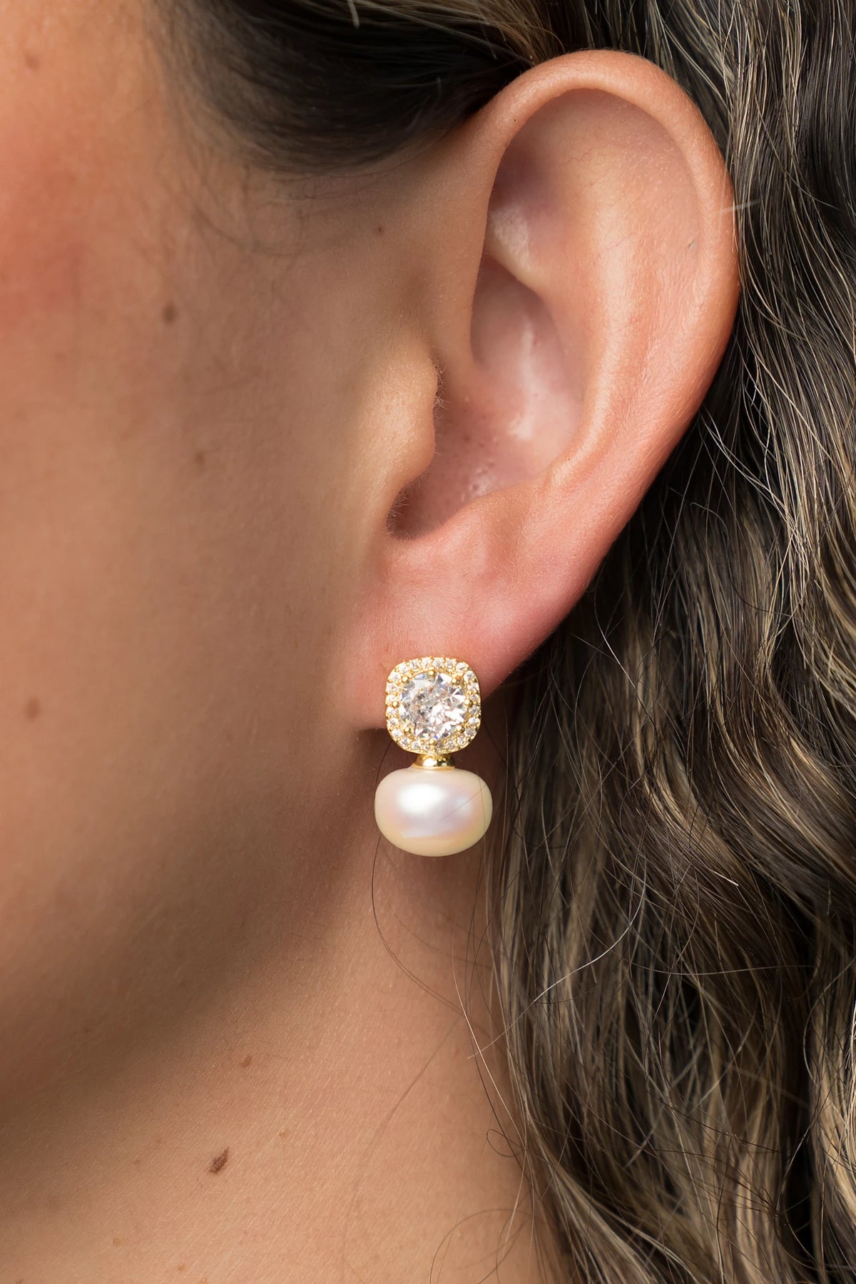 Laurent Pearl Halo Stud Earrings in Gold with cubic zirconia halo and faux pearl drop.