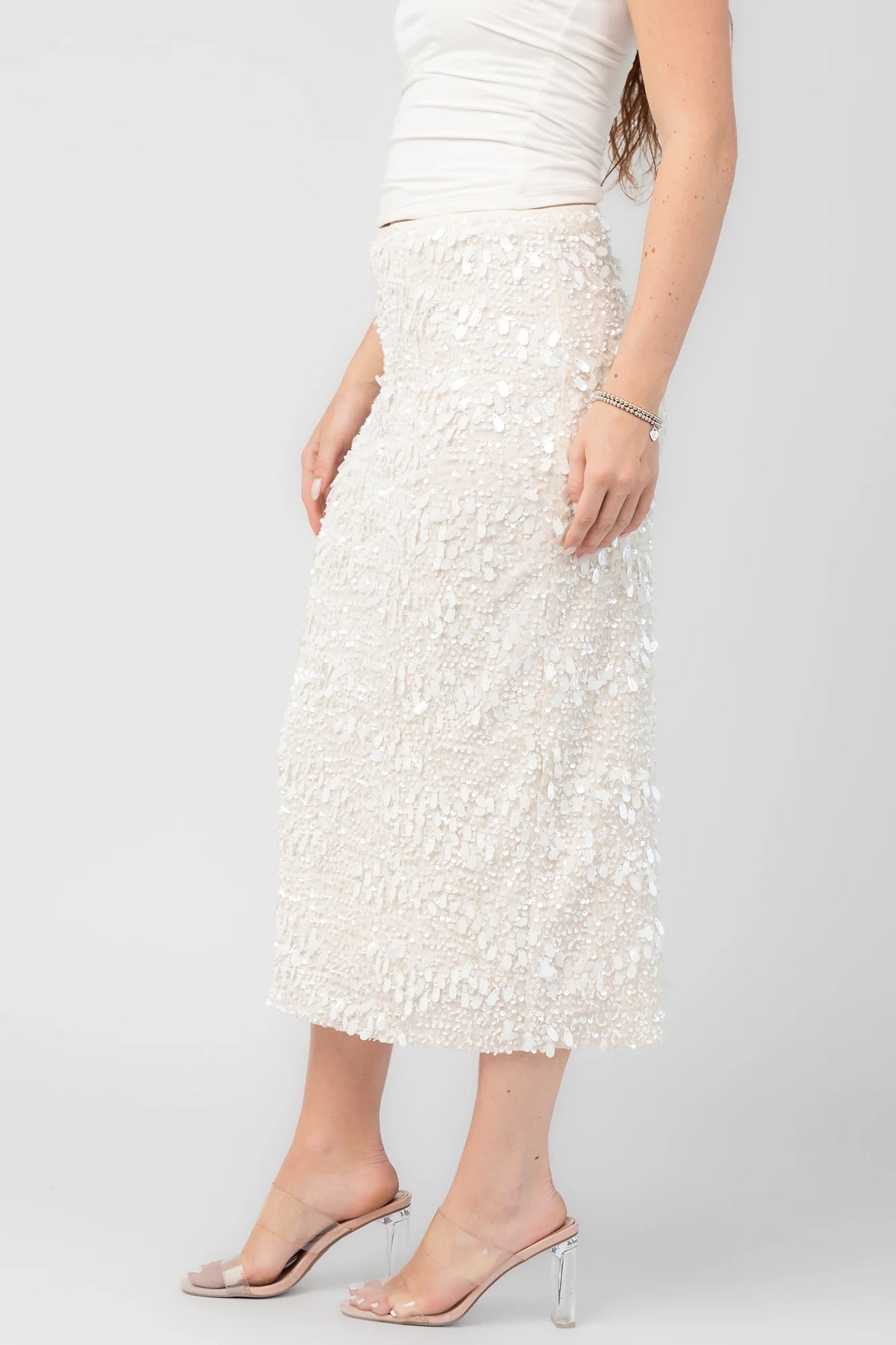 Lavana Sequin Skirt in Ivory with dimensional sequin embellishments, midi length, and fitted silhouette.