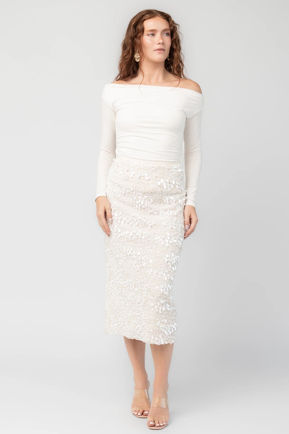 Lavana Sequin Skirt in Ivory with dimensional sequin embellishments, midi length, and fitted silhouette.