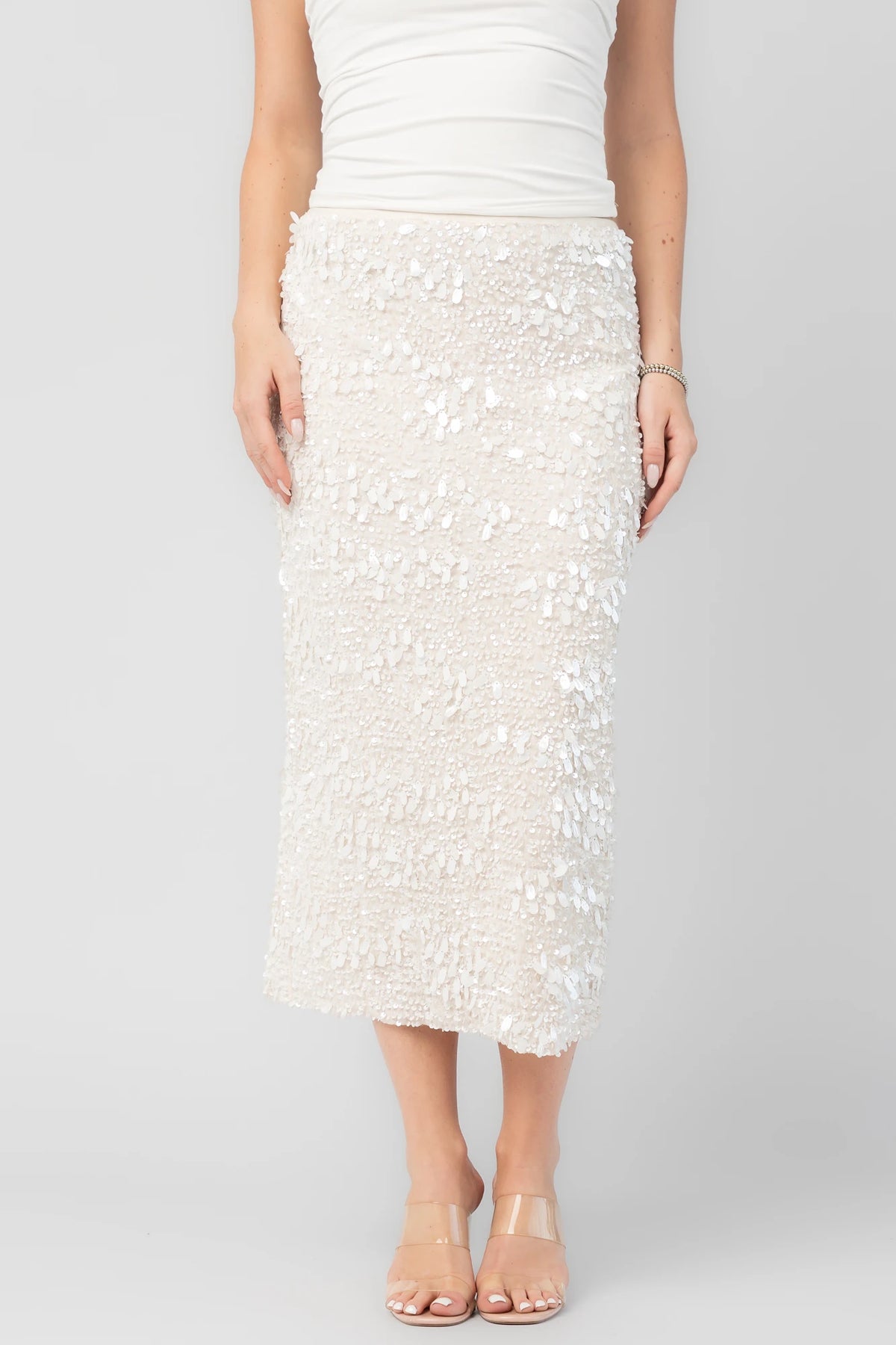 Lavana Sequin Skirt in Ivory with dimensional sequin embellishments, midi length, and fitted silhouette.