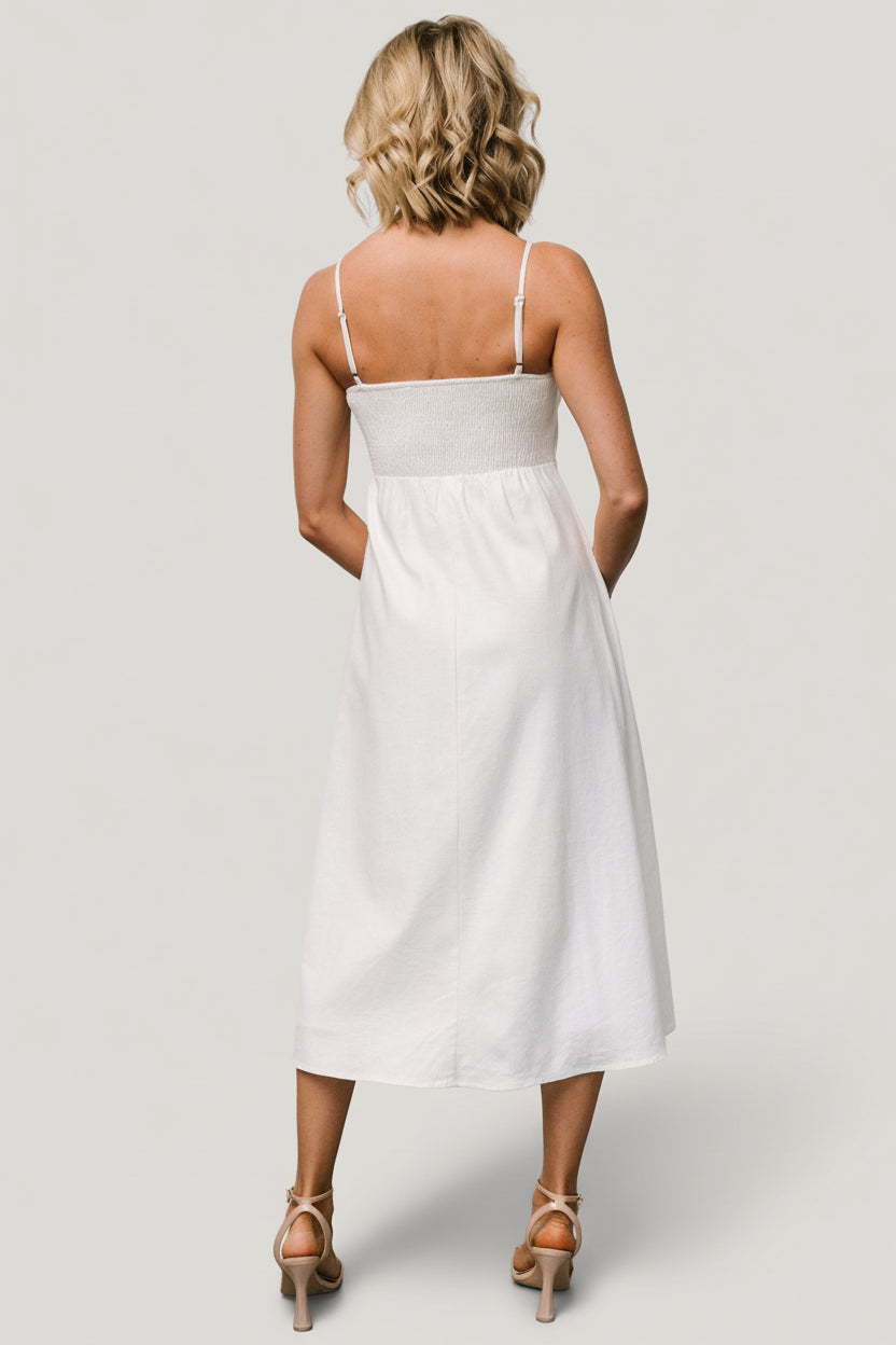 Back view of the ivory midi dress showing the smocked back panel and adjustable straps for added comfort and flexible fit.