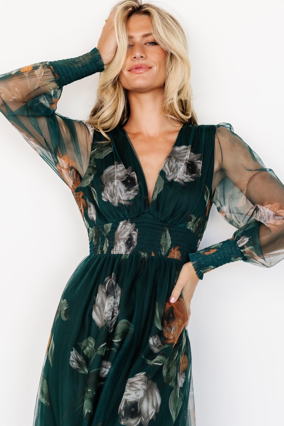 Front view of deep Topaz floral tulle maxi dress showing V-neckline, fitted smocked waist and floor-length flowing hem.