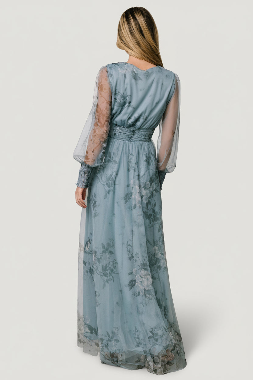 Detail shot of smocked sleeve cuff and sheer tulle sleeve with floral print visible against the lining beneath.