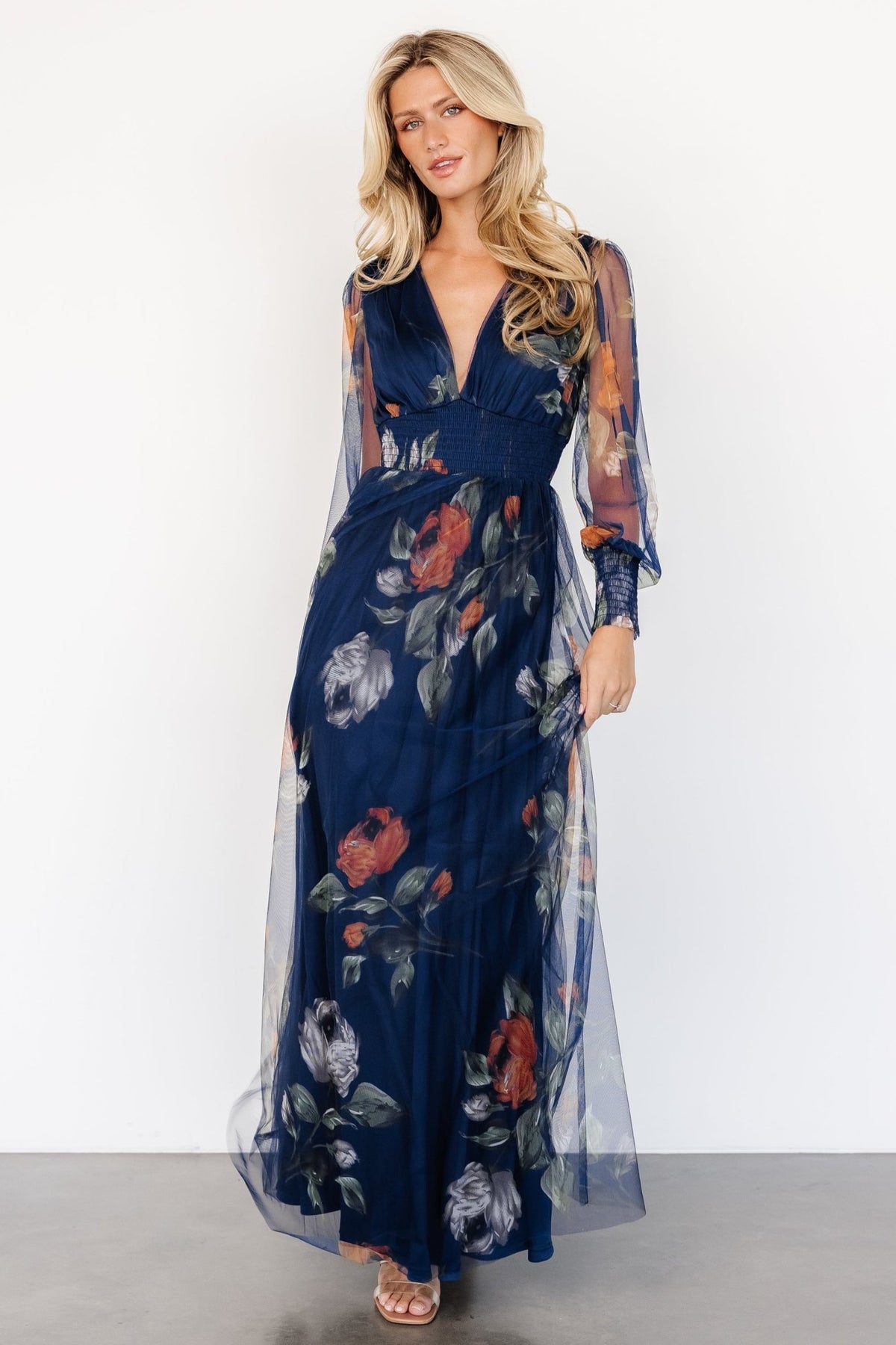 Back view of Layla Tulle Maxi Dress in navy floral, showing lining coverage and soft raw hem finish.