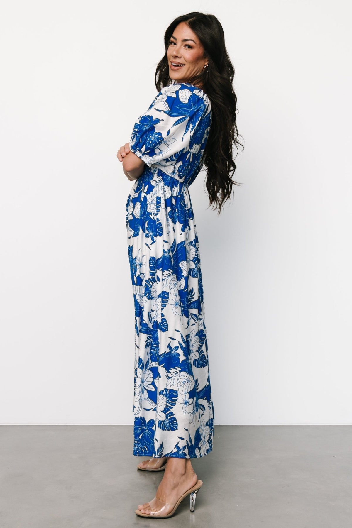 Back view of Leela Maxi Dress showing elastic at back waist for shape, textured rayon blend fabric, and full-length floral skirt movement.