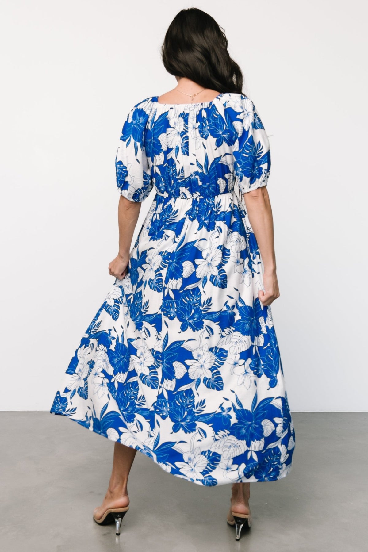 Side view of the Leela floral maxi dress demonstrating the flowing maxi skirt, in-seam side pockets, and lined front bodice for modest coverage.