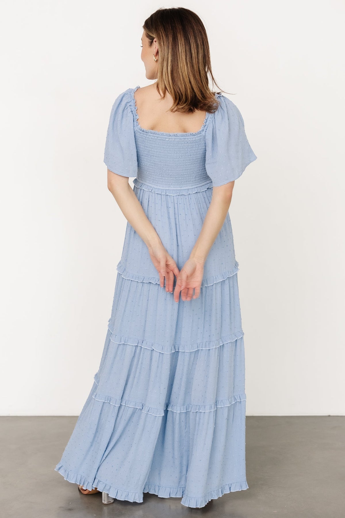 Close-up of smocked bodice and dotted texture on the dusty blue Lenora maxi dress, showing elastic detailing and fine fabric dots.