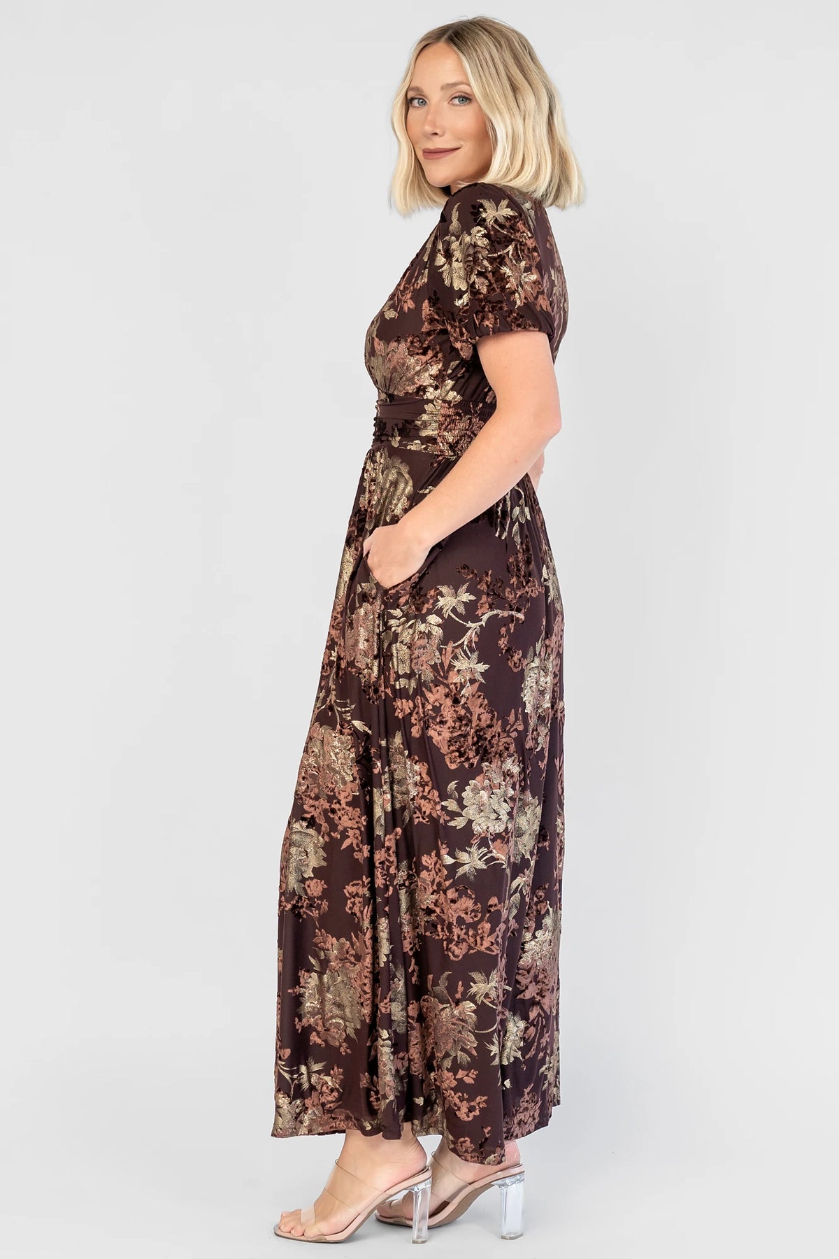 Leslie Velvet Maxi Dress in Brown + Metallic Gold with an embossed velvet floral design, a V-neckline, and puff sleeves.