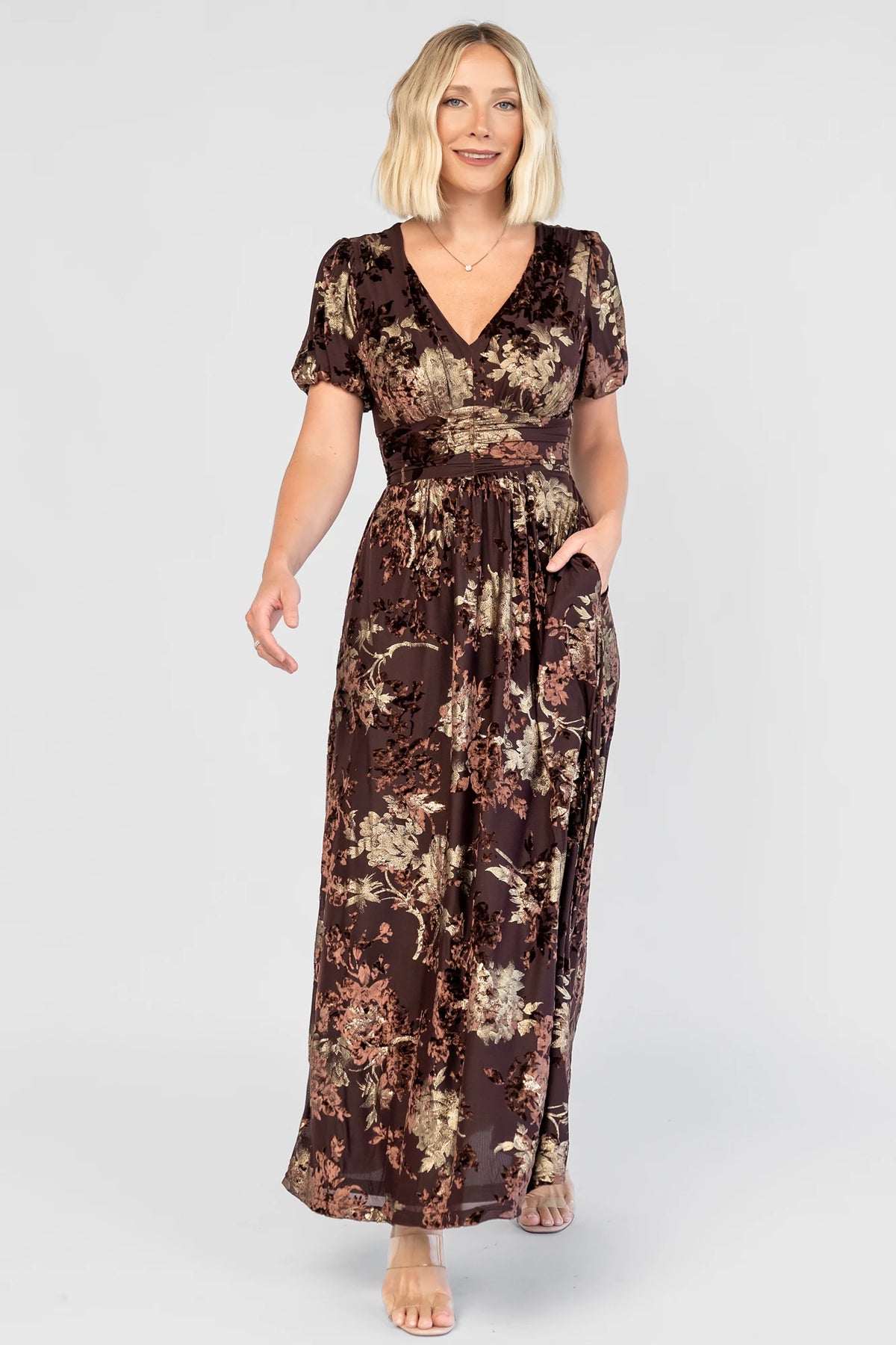 Leslie Velvet Maxi Dress in Brown + Metallic Gold with an embossed velvet floral design, a V-neckline, and puff sleeves.