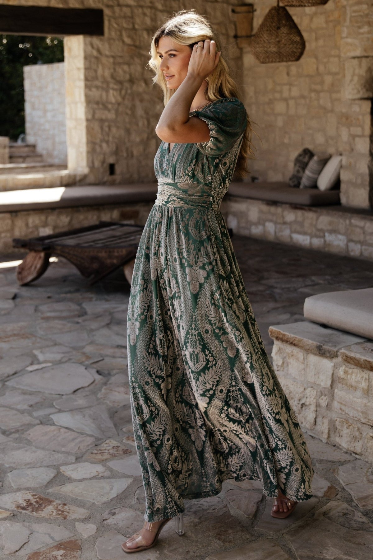 Model movement shot in the Leslie Velvet Maxi Dress, Sage + Silver, showing skirt swing and how the embossed velvet flows.