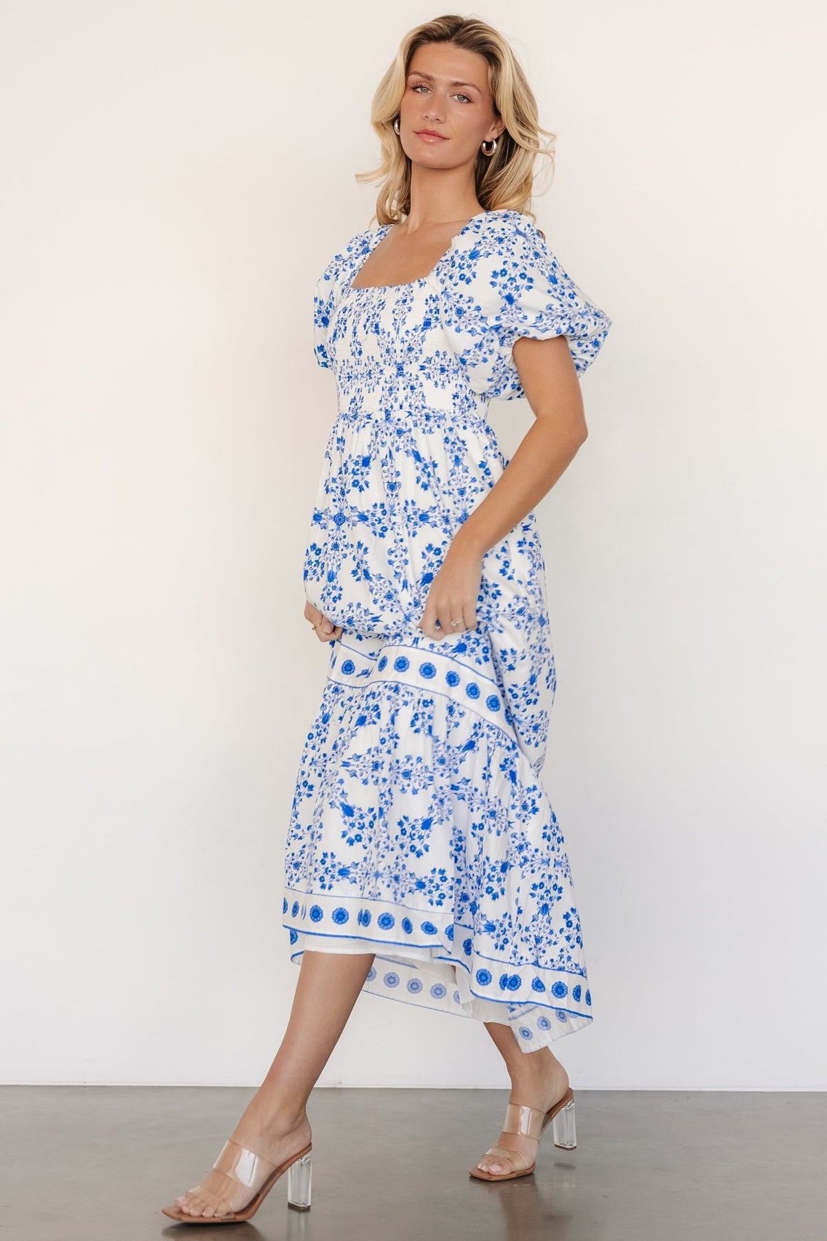 Styled look of the Lexa maxi dress on model, showing full length, tiered silhouette, smocked bodice and practical side pockets.