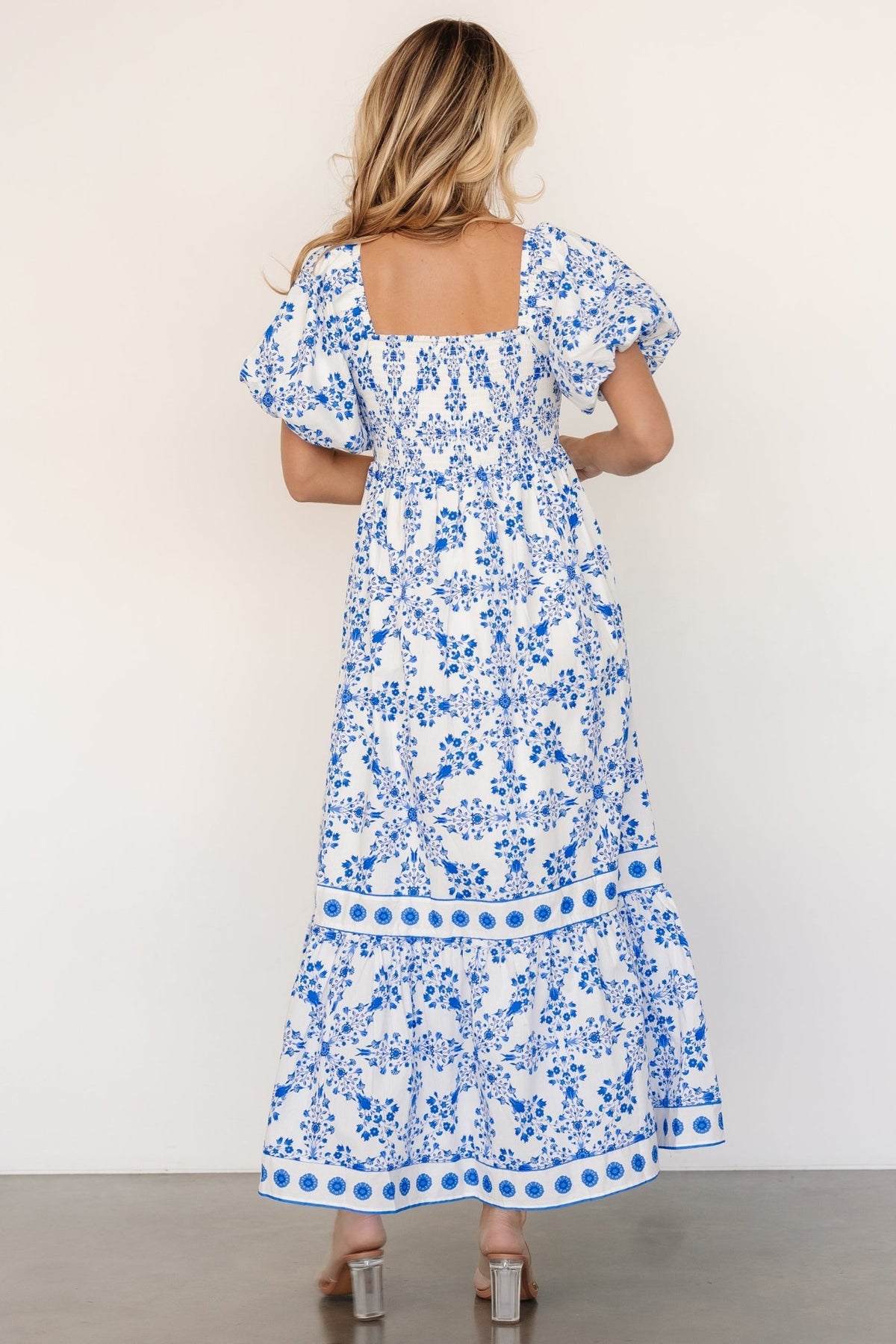 Close-up of smocked bodice and square ruffle neckline with elastic detailing, showing texture and stretch in the cotton fabric.