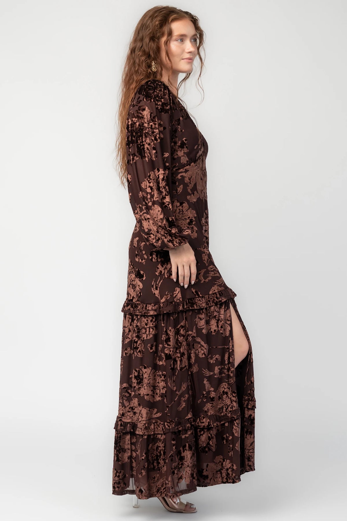 Liana Velvet Embossed Ruffle-Tier Maxi Dress in Brown with V-neck, long sleeves, elastic waist, and tiered skirt.