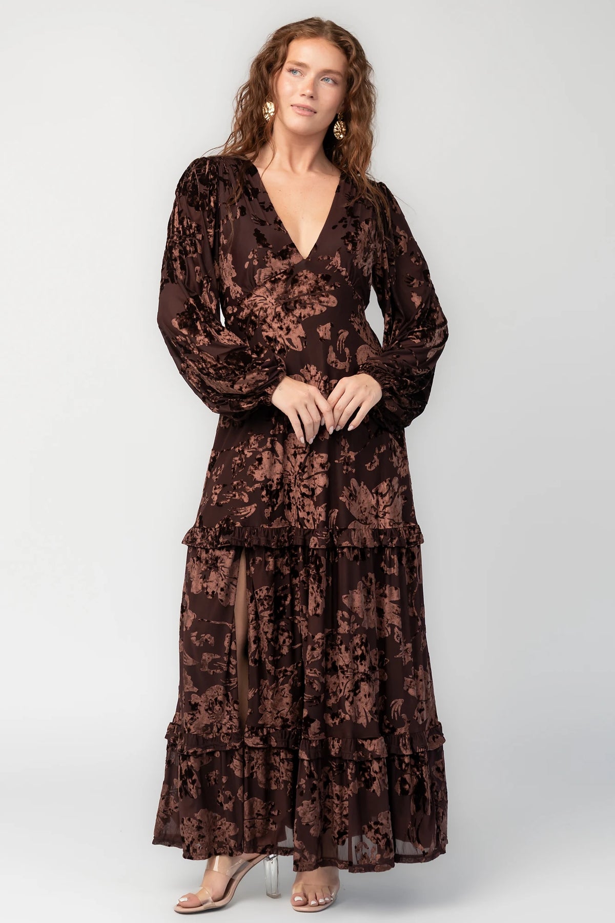 Liana Velvet Embossed Ruffle-Tier Maxi Dress in Brown with V-neck, long sleeves, elastic waist, and tiered skirt.