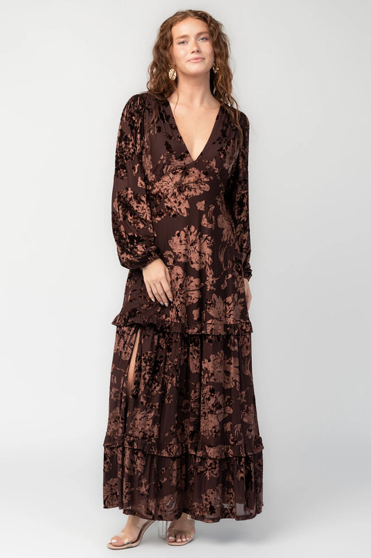 Liana Velvet Embossed Ruffle-Tier Maxi Dress in Brown with V-neck, long sleeves, elastic waist, and tiered skirt.