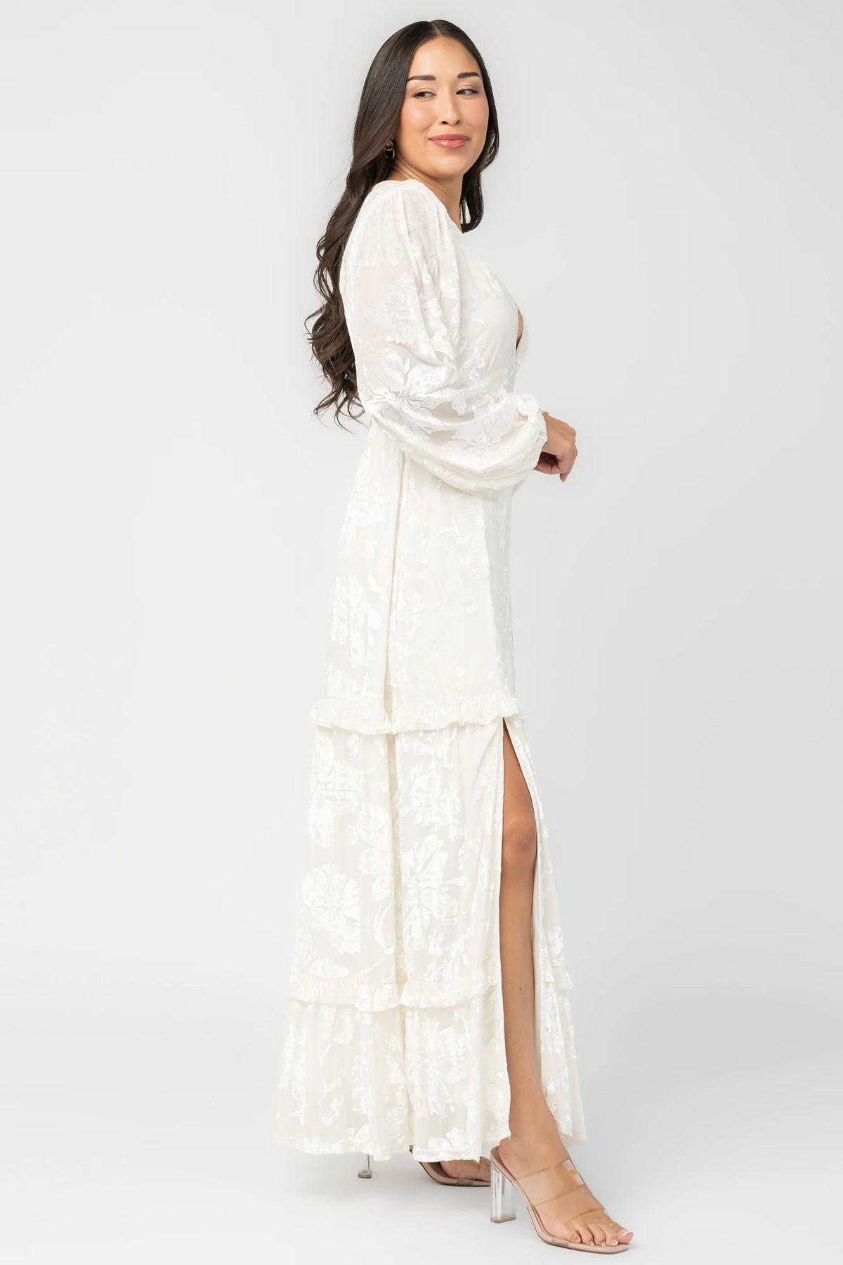 Liana Velvet Embossed Ruffle-Tier Maxi Dress in Ivory with V-neck, long sleeves, and ruffle-tiered skirt.