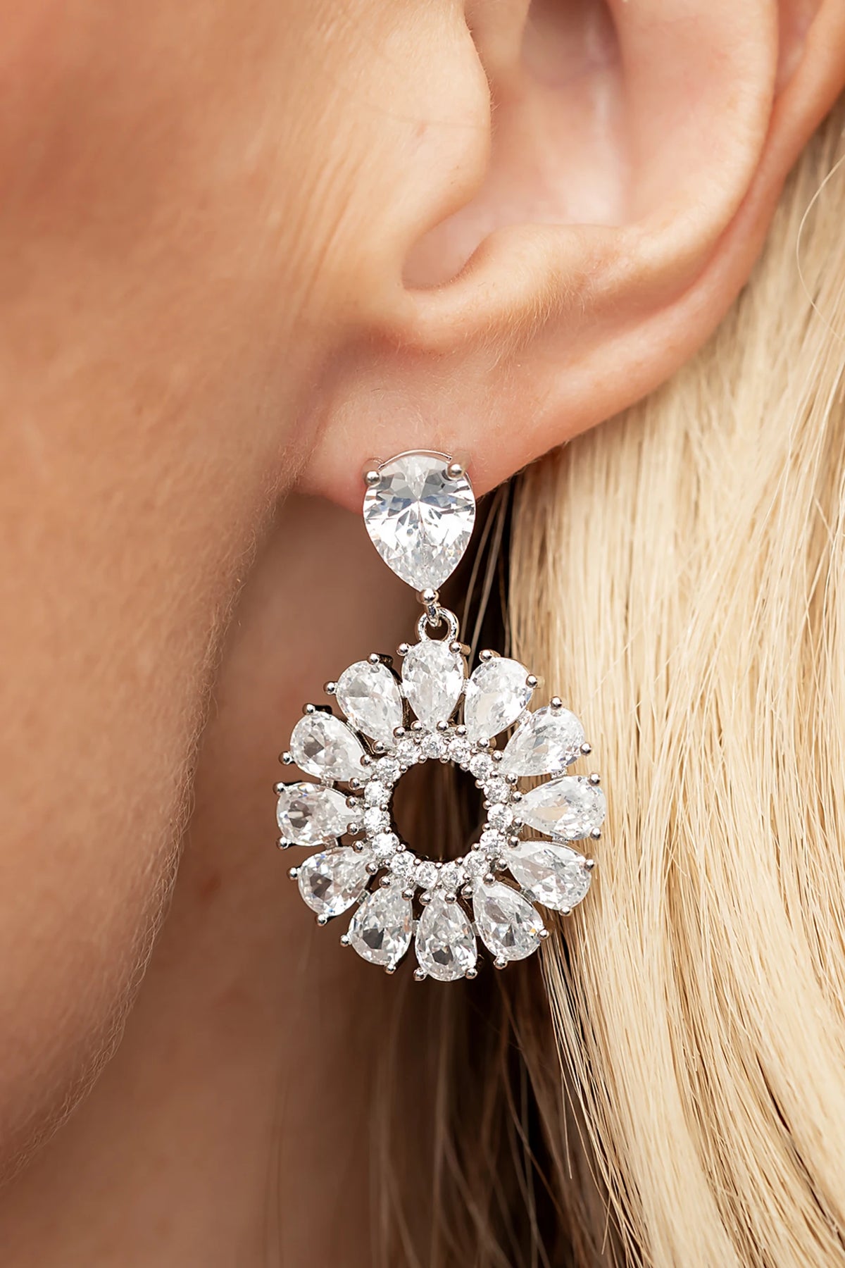 Lisandra Cluster Drop Earrings in Silver with teardrop studs, clear faceted stones, and circular cluster drops.