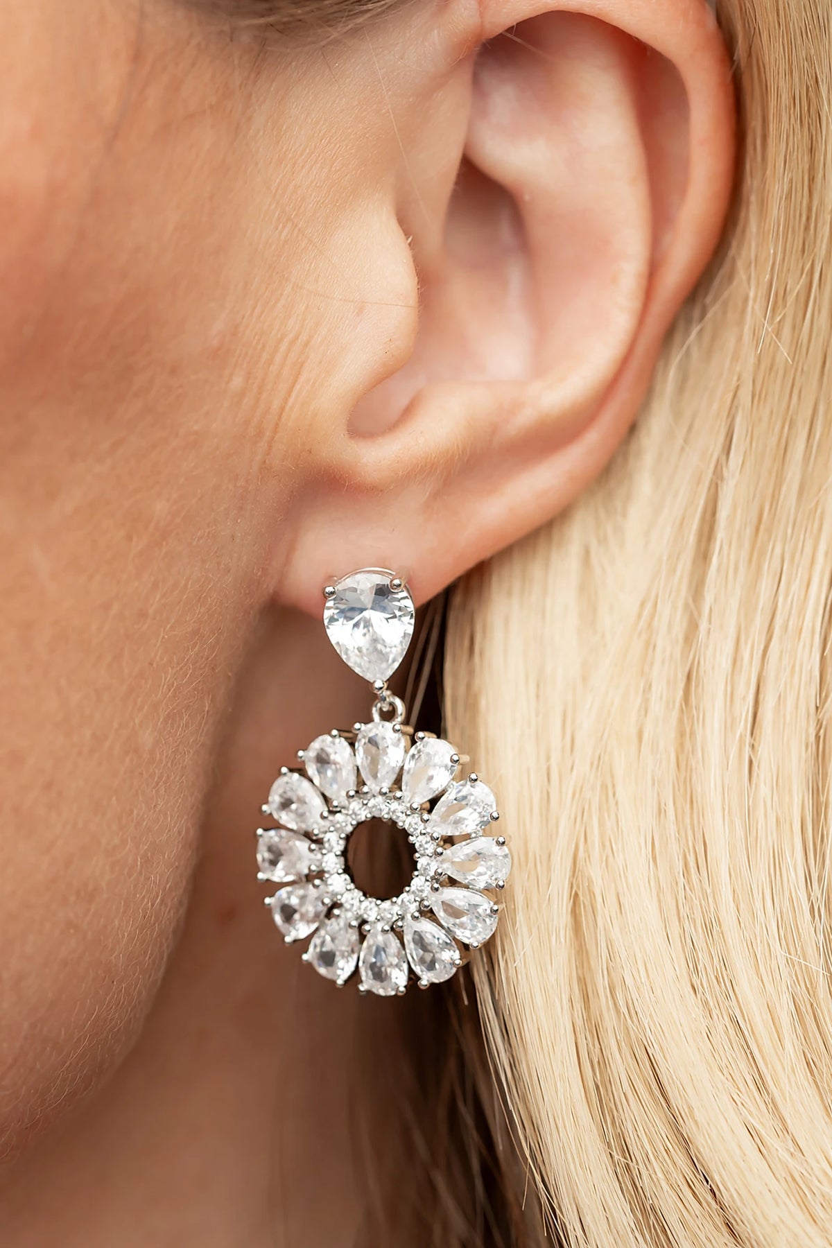 Lisandra Cluster Drop Earrings in Silver with teardrop studs, clear faceted stones, and circular cluster drops.