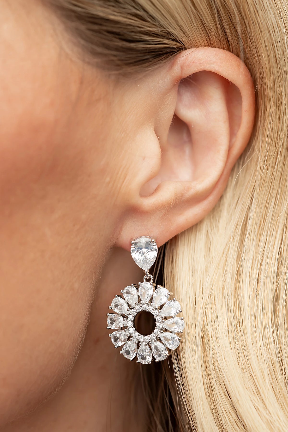 Lisandra Cluster Drop Earrings in Silver with teardrop studs, clear faceted stones, and circular cluster drops.