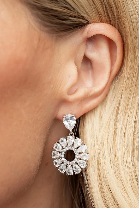 Lisandra Cluster Drop Earrings in Silver with teardrop studs, clear faceted stones, and circular cluster drops.