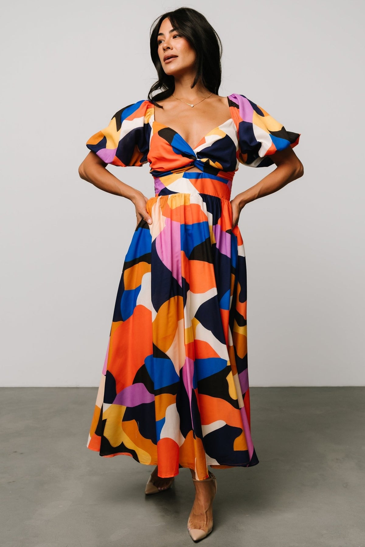 Front view of Lola midi dress in rust and navy multi abstract print, showing wide sweetheart neckline and smocked high waist bodice.