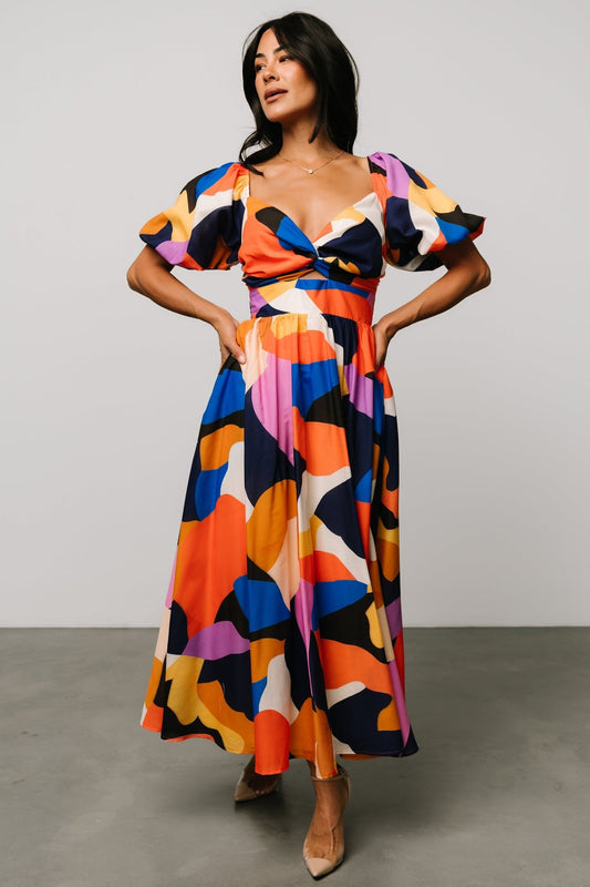 Front view of Lola midi dress in rust and navy multi abstract print, showing wide sweetheart neckline and smocked high waist bodice.
