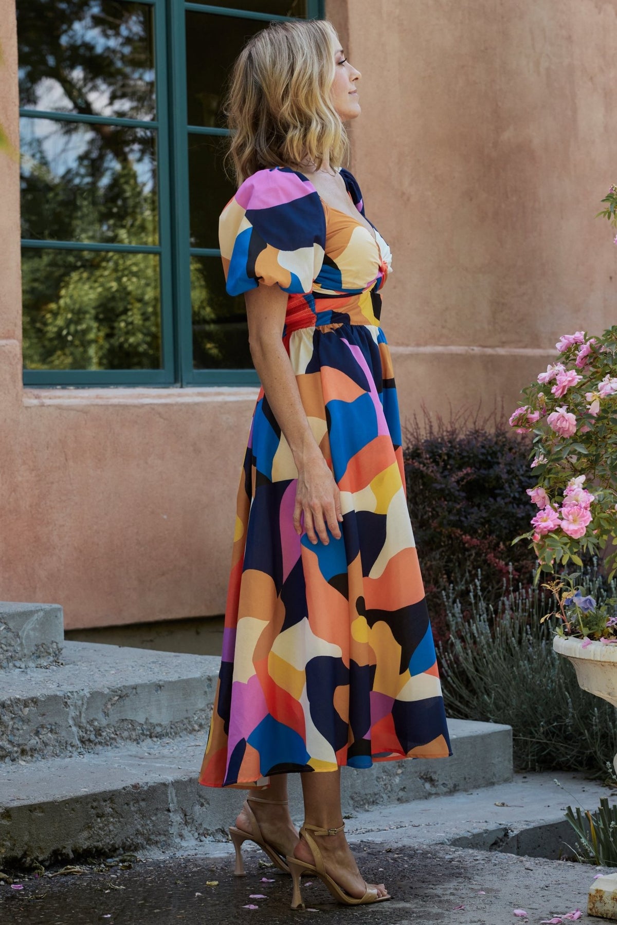 Side view of Lola midi dress showing hidden side pocket and the full swing of the circle skirt in motion.