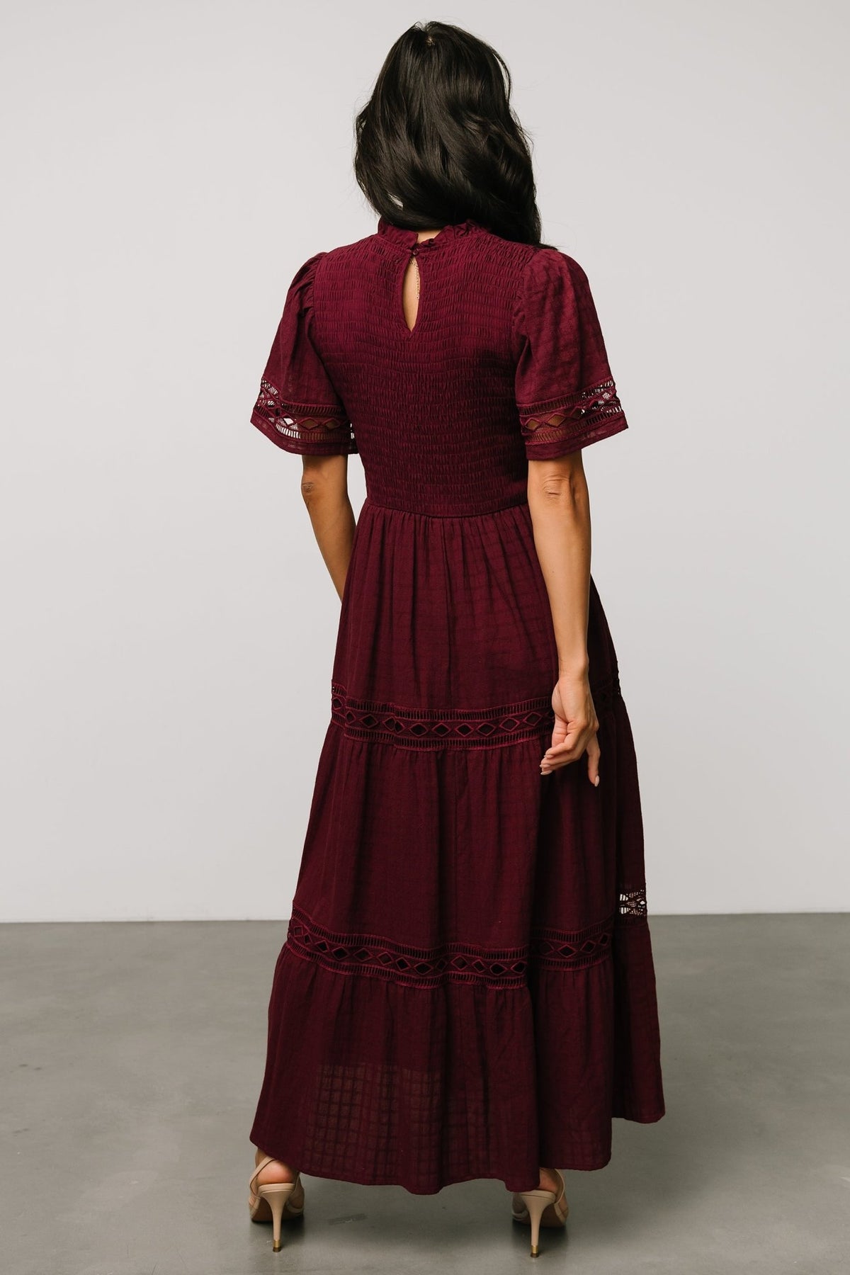 Model close-up showing fit at the waist and smocked bodice with elastic waist that provides stretch and shaping without constriction.