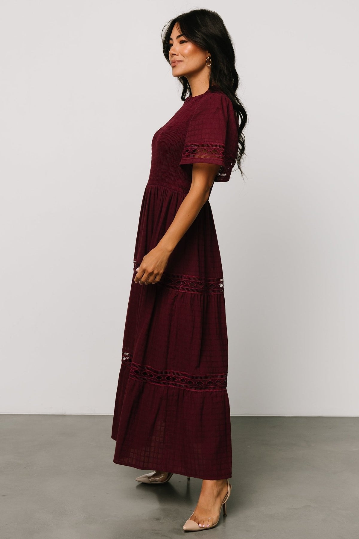 Detail close-up of sleeve and side seam showing oversized short sleeve design and discreet side pocket opening on the skirt.