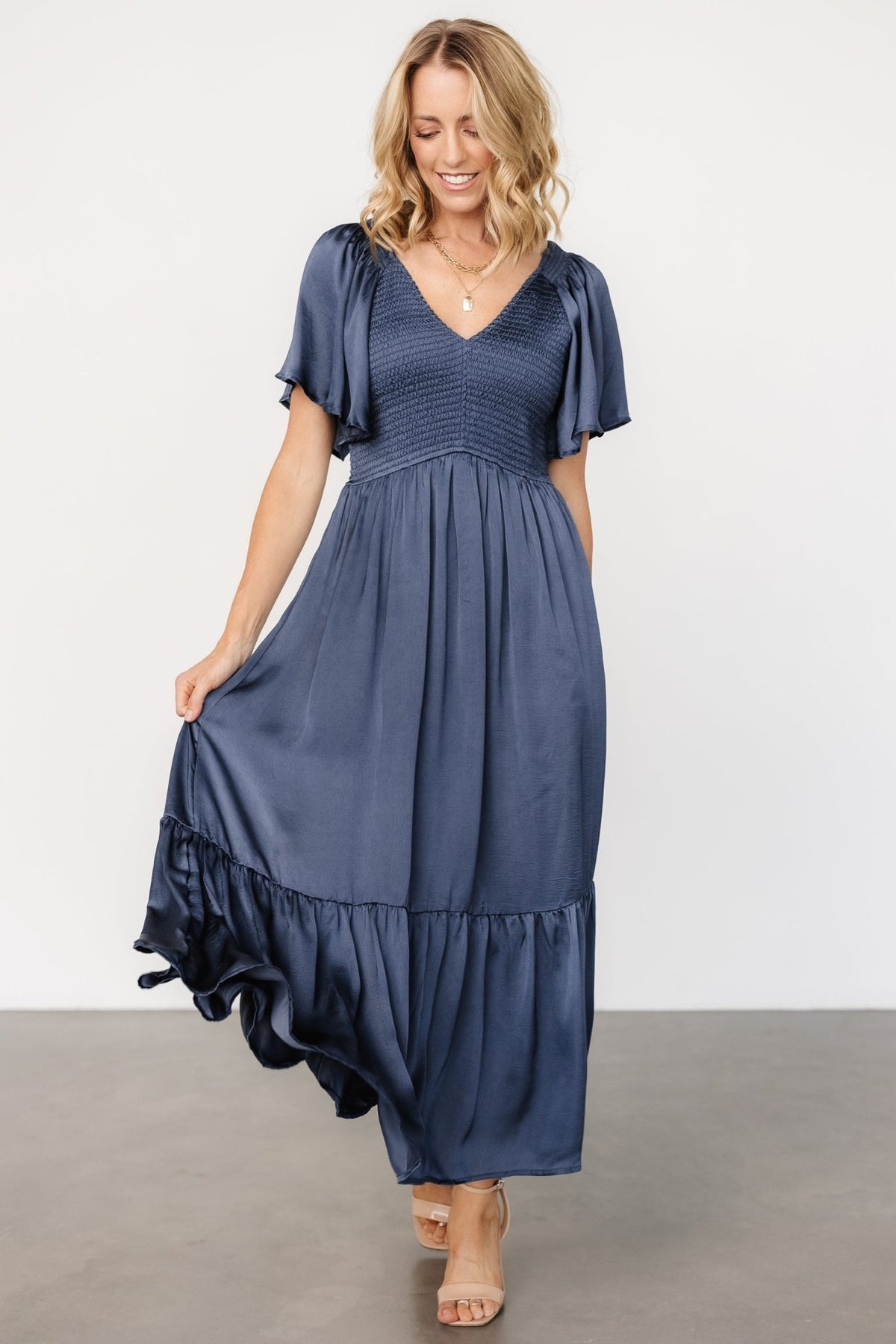 Close-up of semi-pleated ruffle hem and stitch detailing on the Lovell Midi Dress, emphasizing movement and finish.