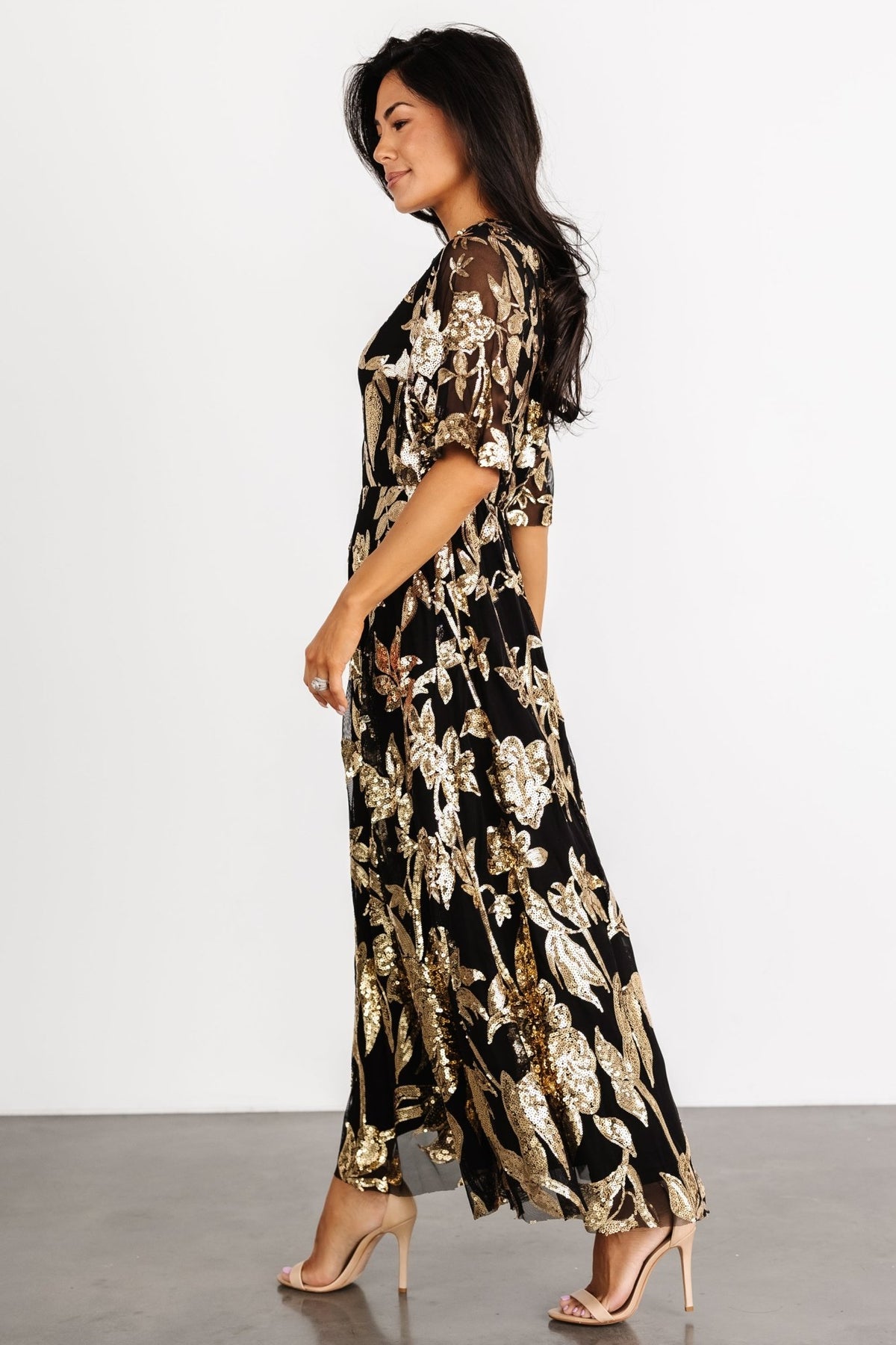 Back view showing the keyhole-and-button closure and gentle gathering at the elastic waistband on the Lucy Sequin Dress.