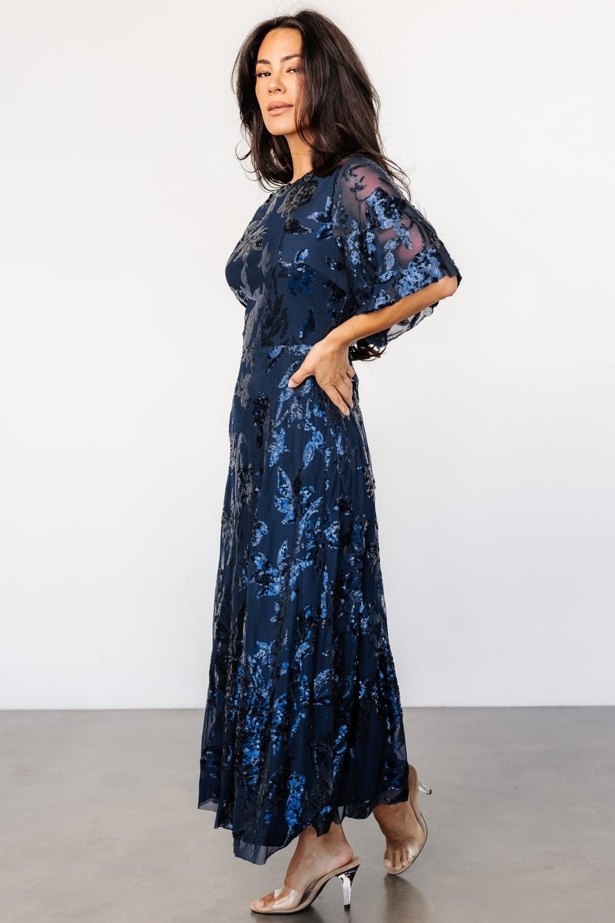 Back view highlighting the keyhole-and-button closure, elasticated waist, and the way the tulle drapes over the lined skirt.