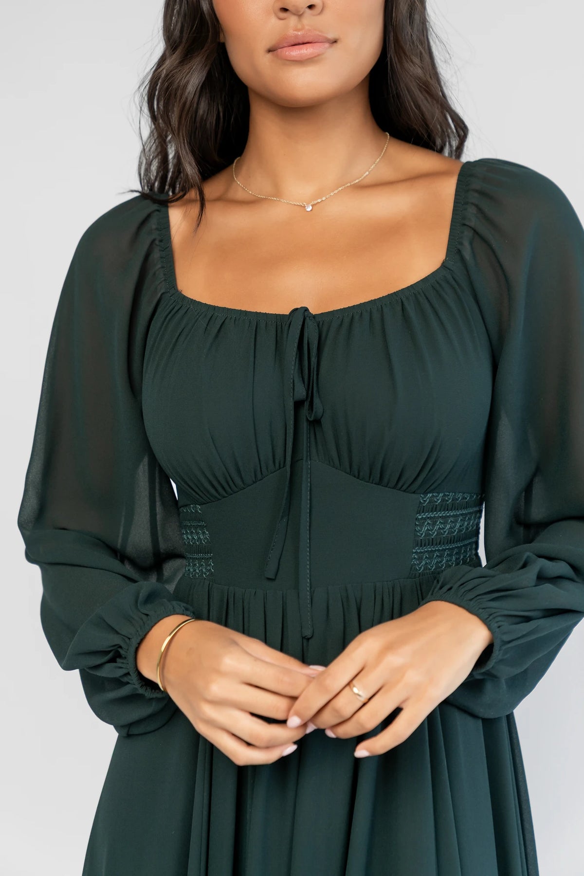 Maddalena Maxi Dress in Dark Green with a sweetheart neckline, embroidered chevron detailing, and long sheer sleeves.