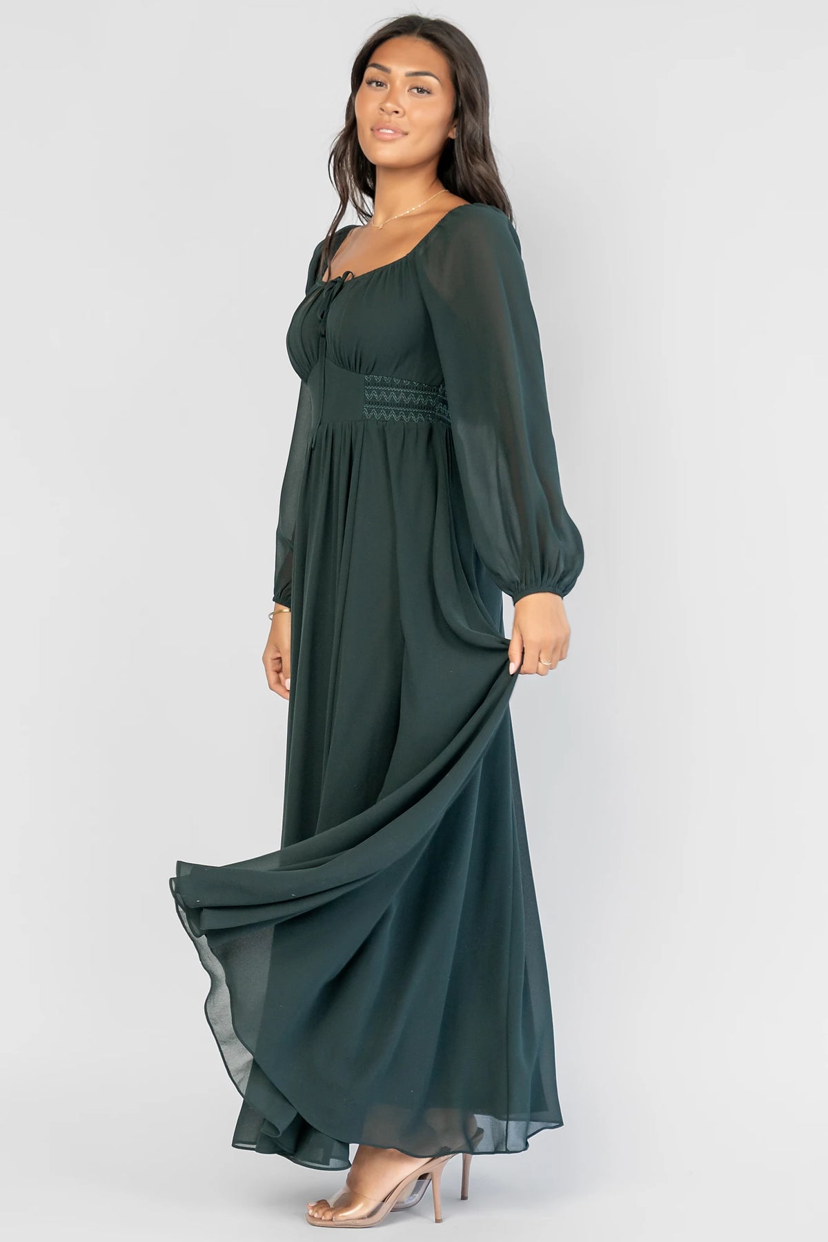 Maddalena Maxi Dress in Dark Green with a sweetheart neckline, embroidered chevron detailing, and long sheer sleeves.