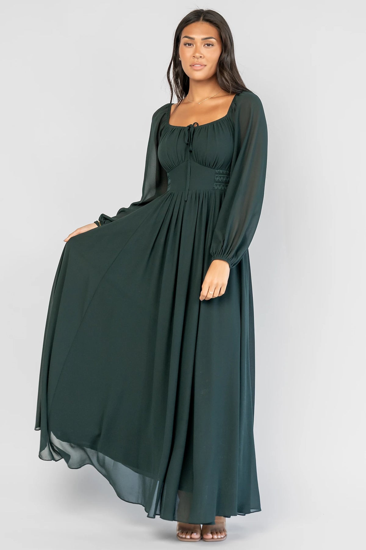 Maddalena Maxi Dress in Dark Green with a sweetheart neckline, embroidered chevron detailing, and long sheer sleeves.