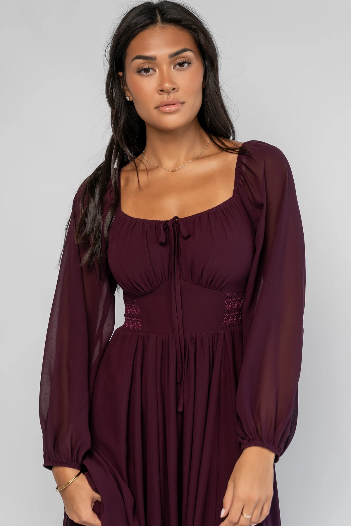Maddalena Maxi Dress in Dark Plum with embroidered chevron detailing, a sweetheart neckline, and sheer sleeves.