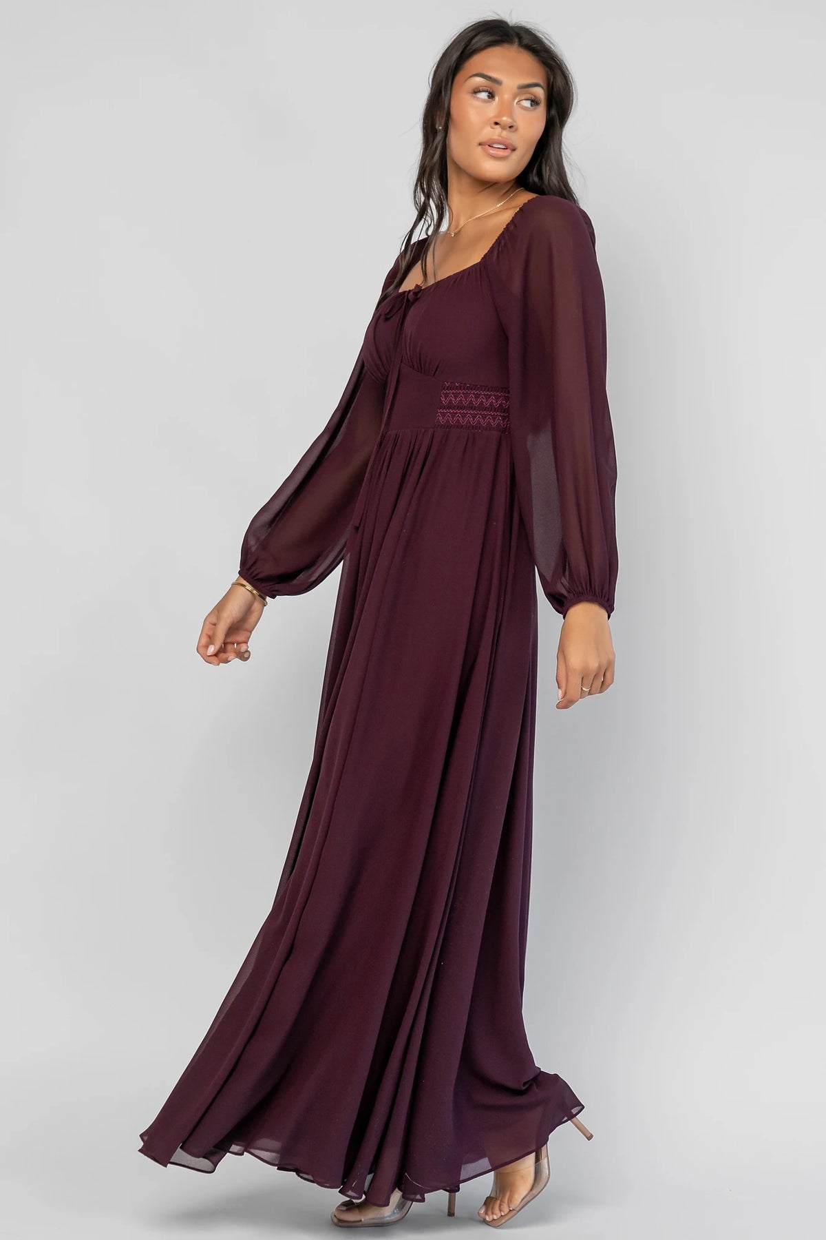 Maddalena Maxi Dress in Dark Plum with embroidered chevron detailing, a sweetheart neckline, and sheer sleeves.