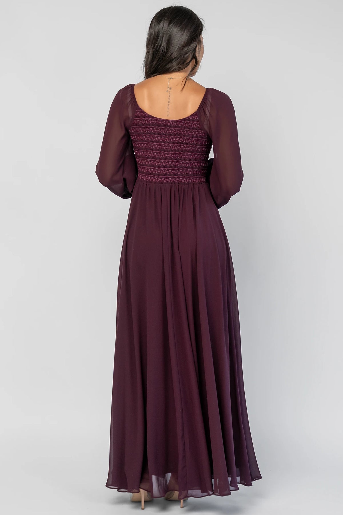 Maddalena Maxi Dress in Dark Plum with embroidered chevron detailing, a sweetheart neckline, and sheer sleeves.
