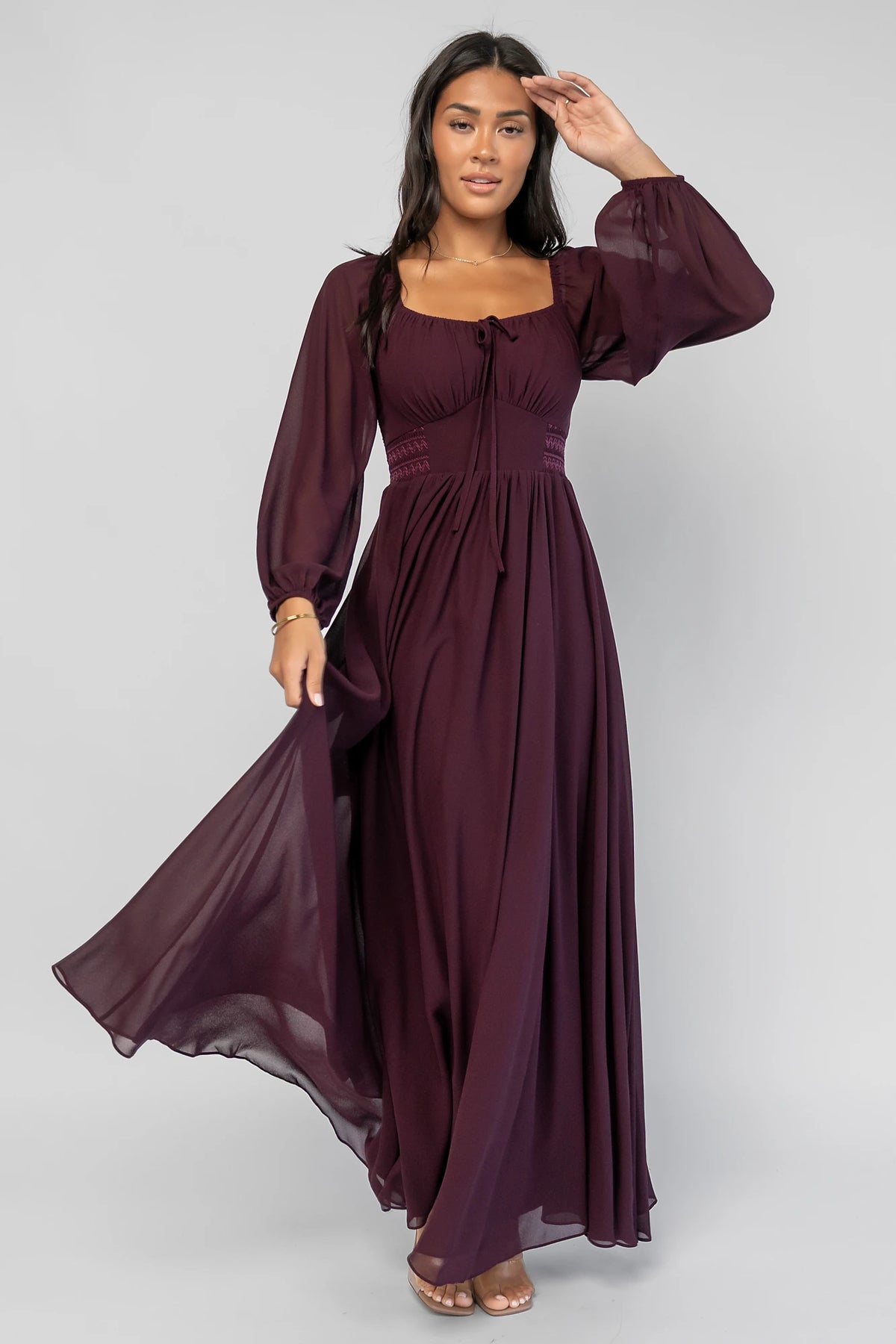 Maddalena Maxi Dress in Dark Plum with embroidered chevron detailing, a sweetheart neckline, and sheer sleeves.