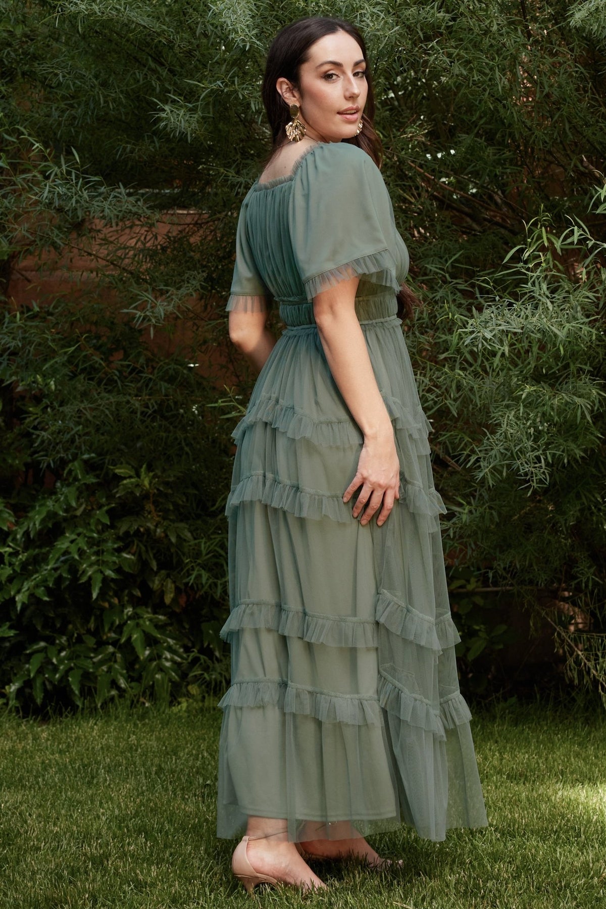 Full-length image of the Magdalena Tulle Maxi Dress in eucalyptus on model, showing silhouette and ruffle tiers for occasion wear.
